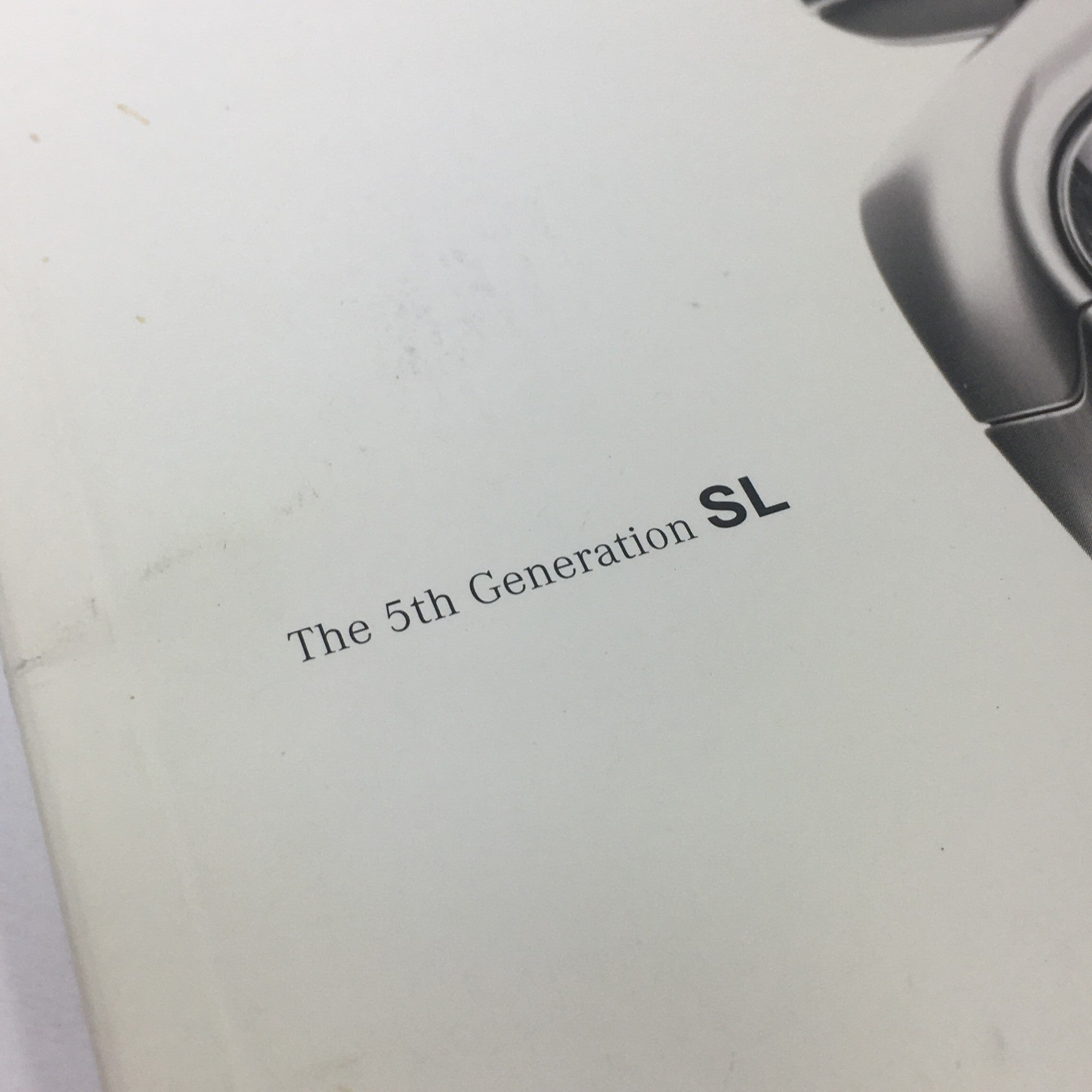 Close-up view of the title 'The 5th Generation SL' on the cover of the 2003 Mercedes-Benz SL-Class Dealership Car Auto Brochure Catalog.