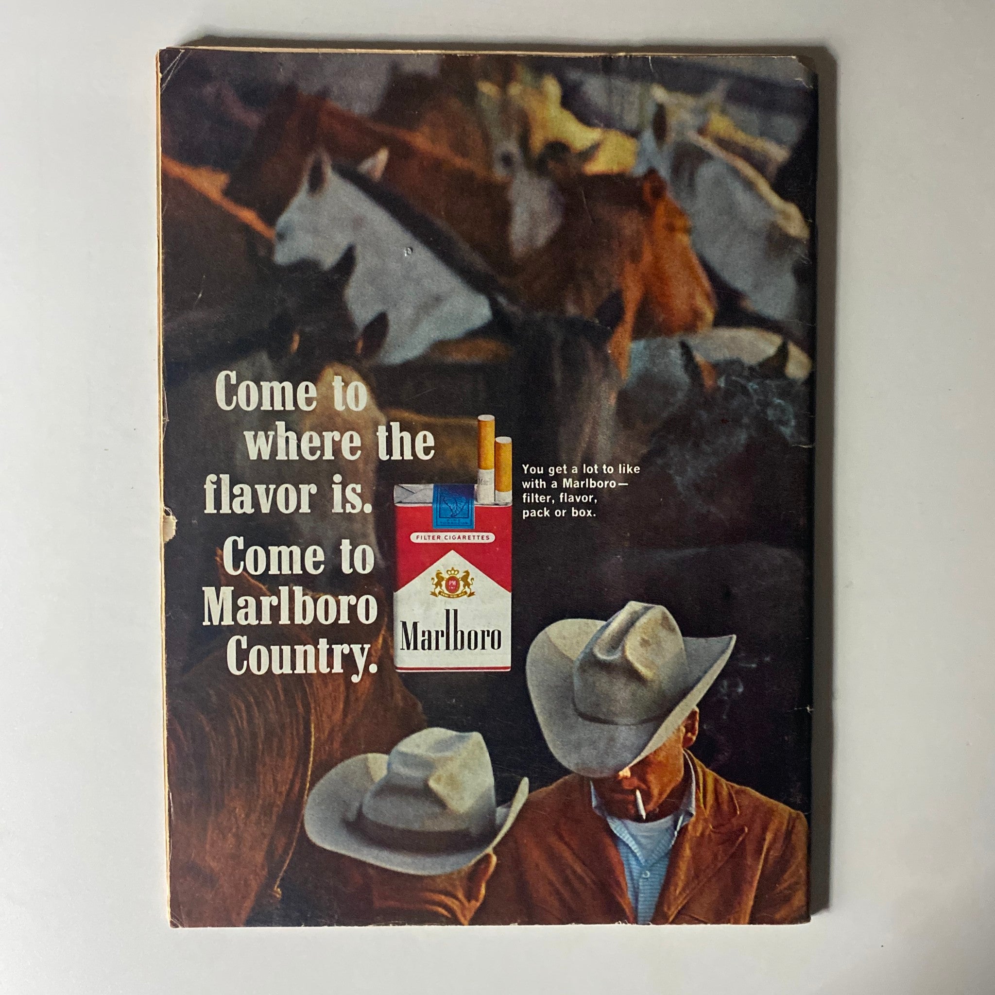 Back cover of a vintage Marlboro advertisement magazine, highlighting the slogan 'Come to Marlboro Country' with an iconic cigarette pack.