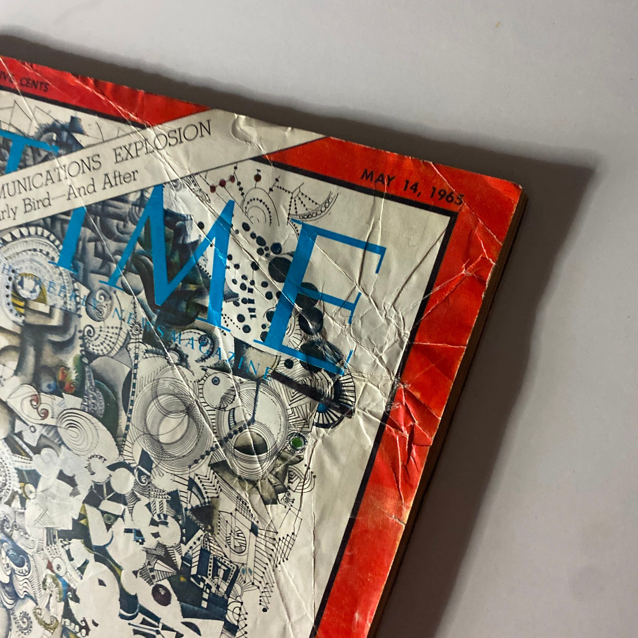 Close-up of the cover of Time Magazine, May 14, 1965, showcasing the intricate artwork and the title 'The Communications Explosion'.