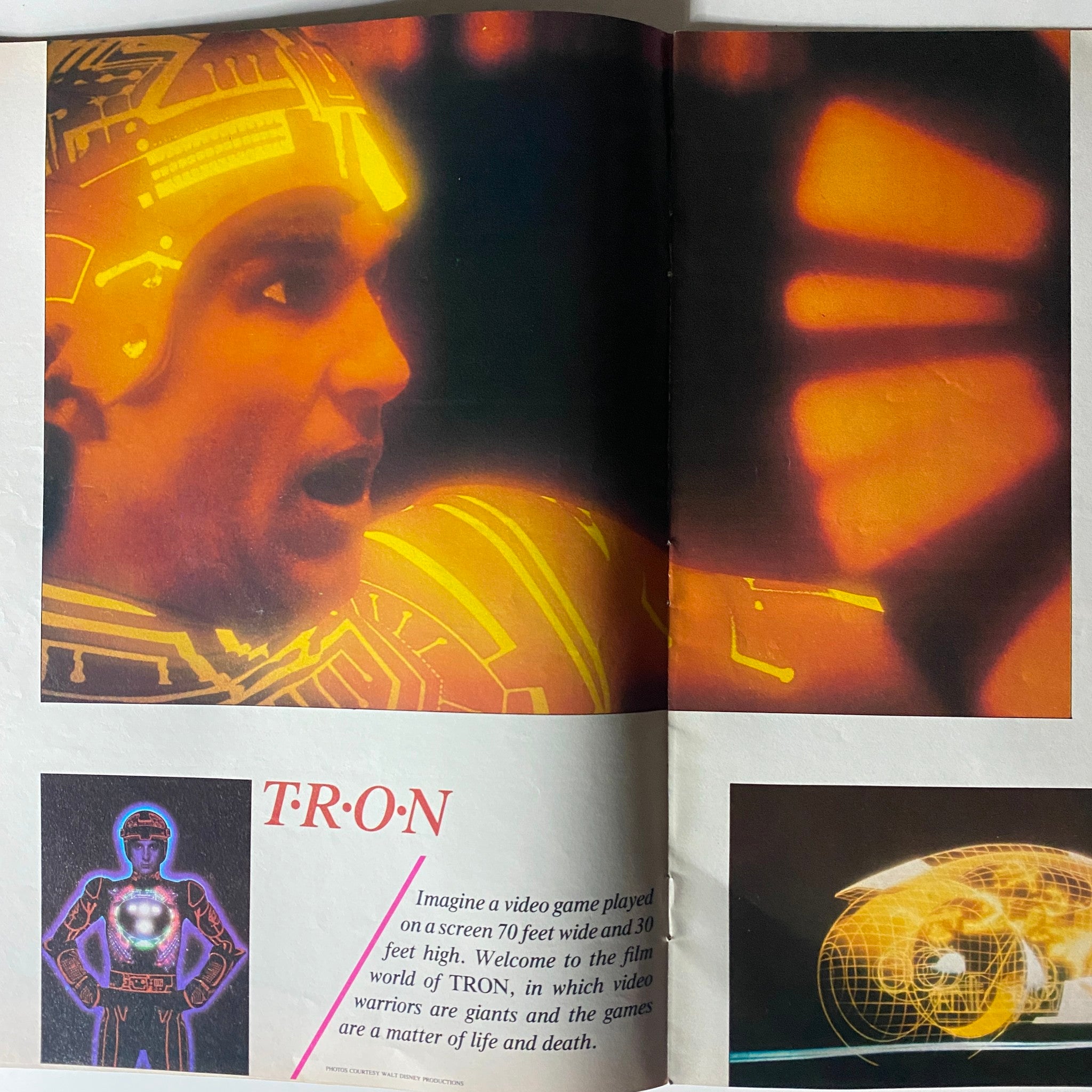 Inside spread of Moviegoer Magazine July 1982 showcasing the film TRON, with a vivid illustration and description of the movie's themes and visuals.