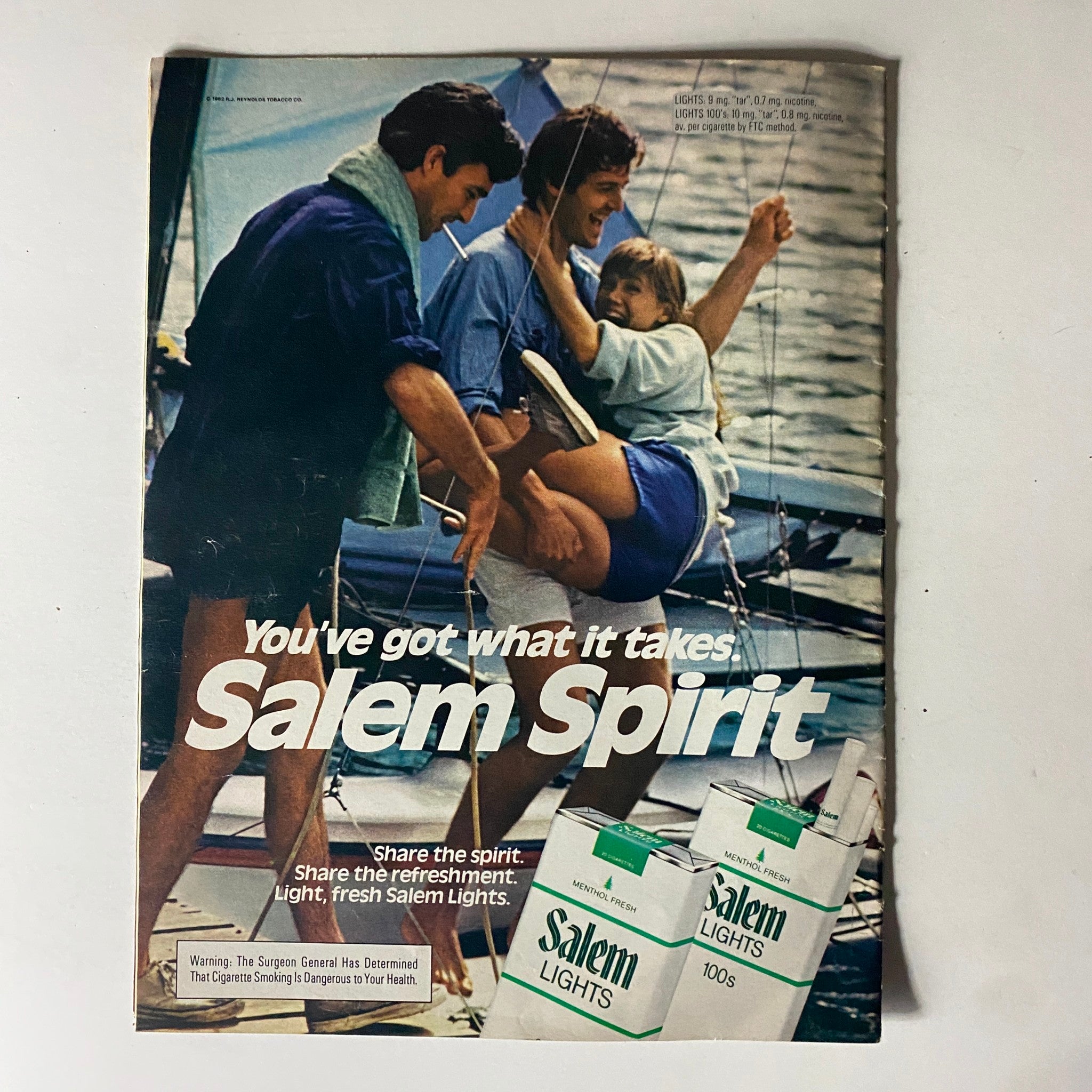 Vintage advertisement from Moviegoer Magazine July 1982 featuring friends enjoying a sailing day, promoting Salem Lights cigarettes.