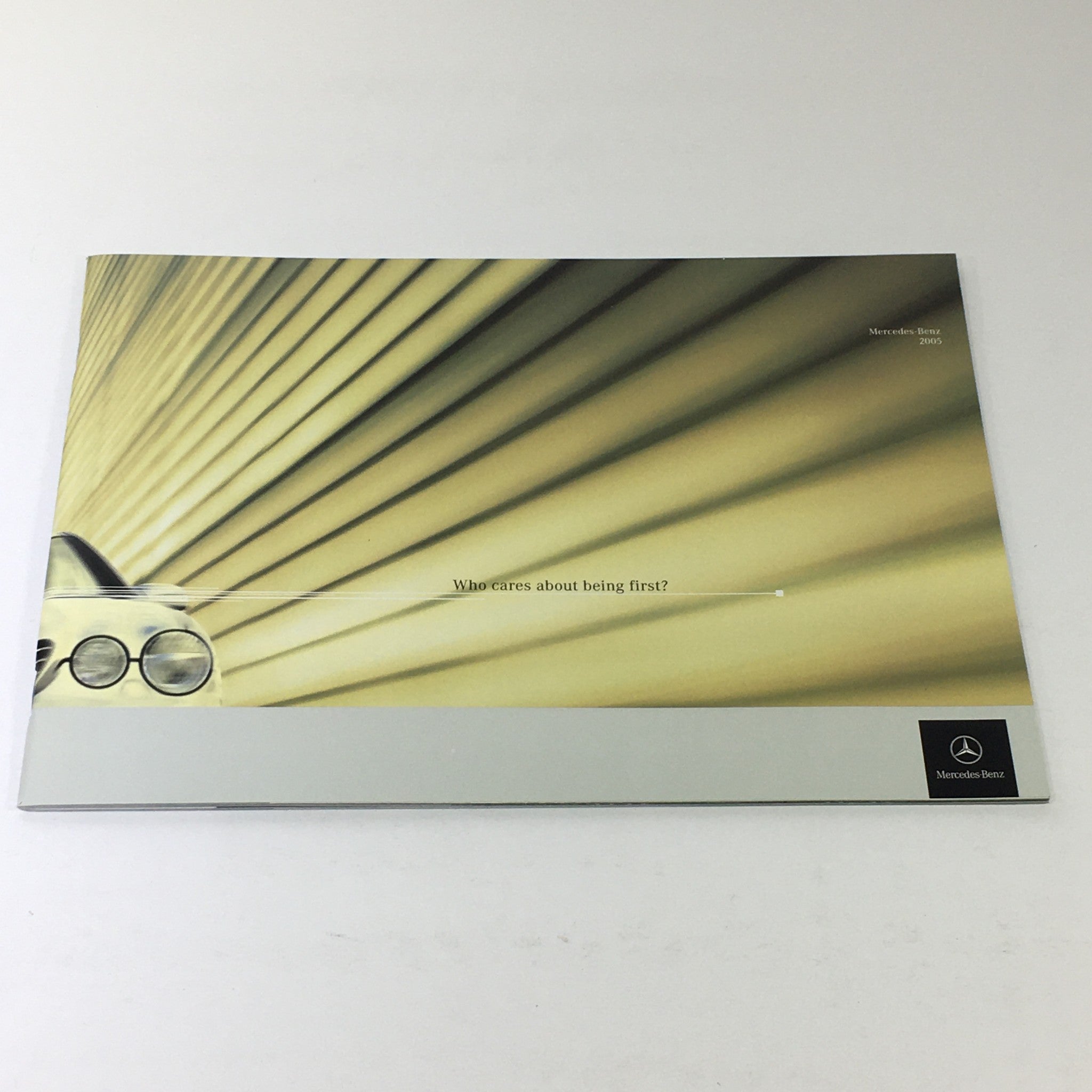 2005 Mercedes-Benz CLK-Class Dealership Car Auto Brochure Catalog cover featuring an abstract design and the tagline 'Who cares about being first?'.