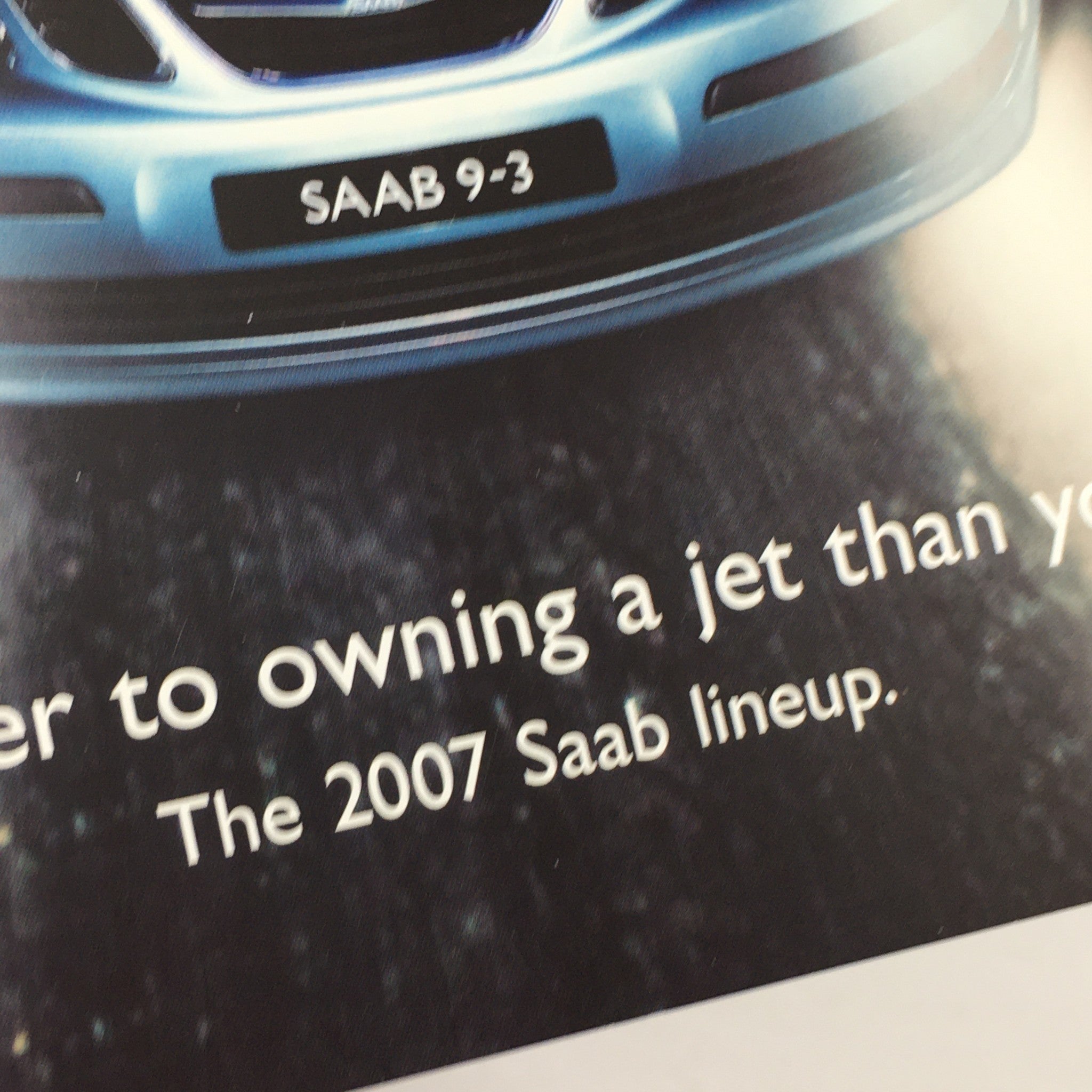 Close-up view of the Saab 9-3 from the 2007 Saab Lineup 93 Sport Sedan Dealership Car Auto Brochure Catalog, highlighting the vehicle's front design.