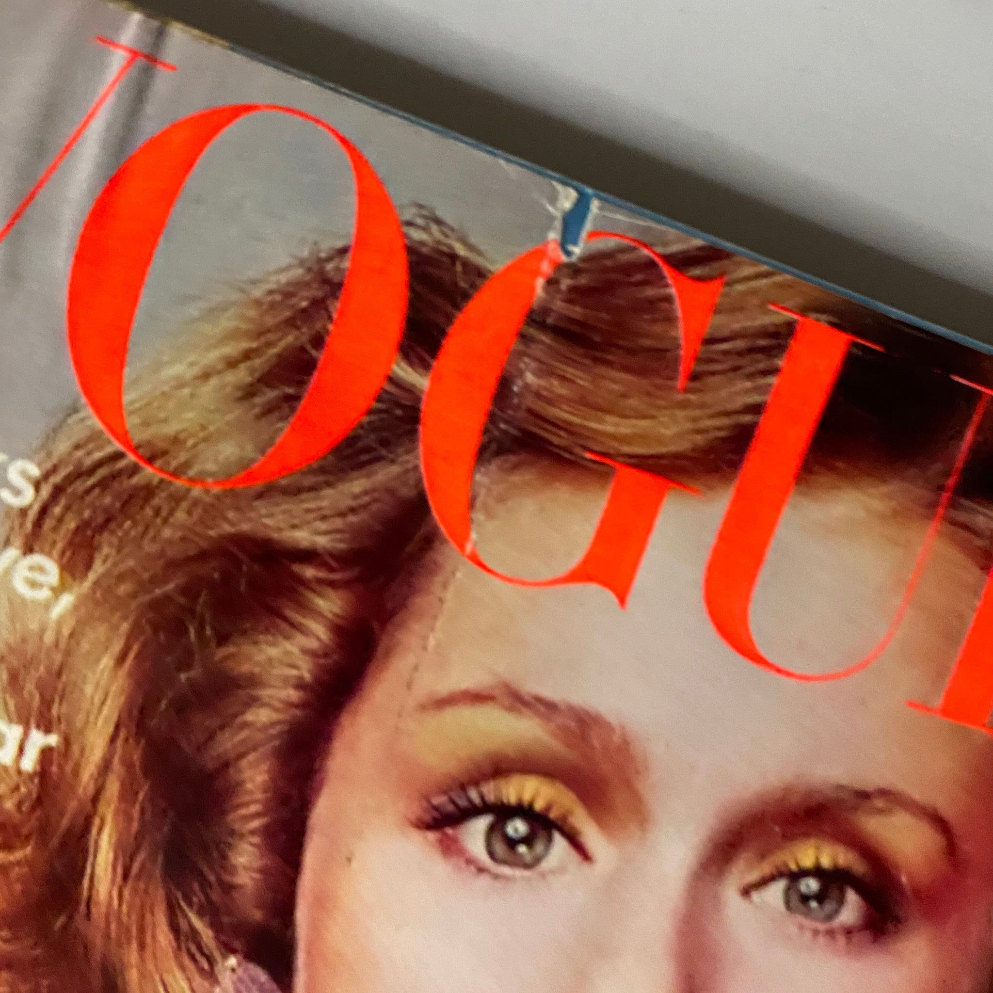 Close-up detail of Vogue Magazine October 1973 cover featuring Lauren Hutton's eyes and hairstyle, highlighting the vintage fashion aesthetic.