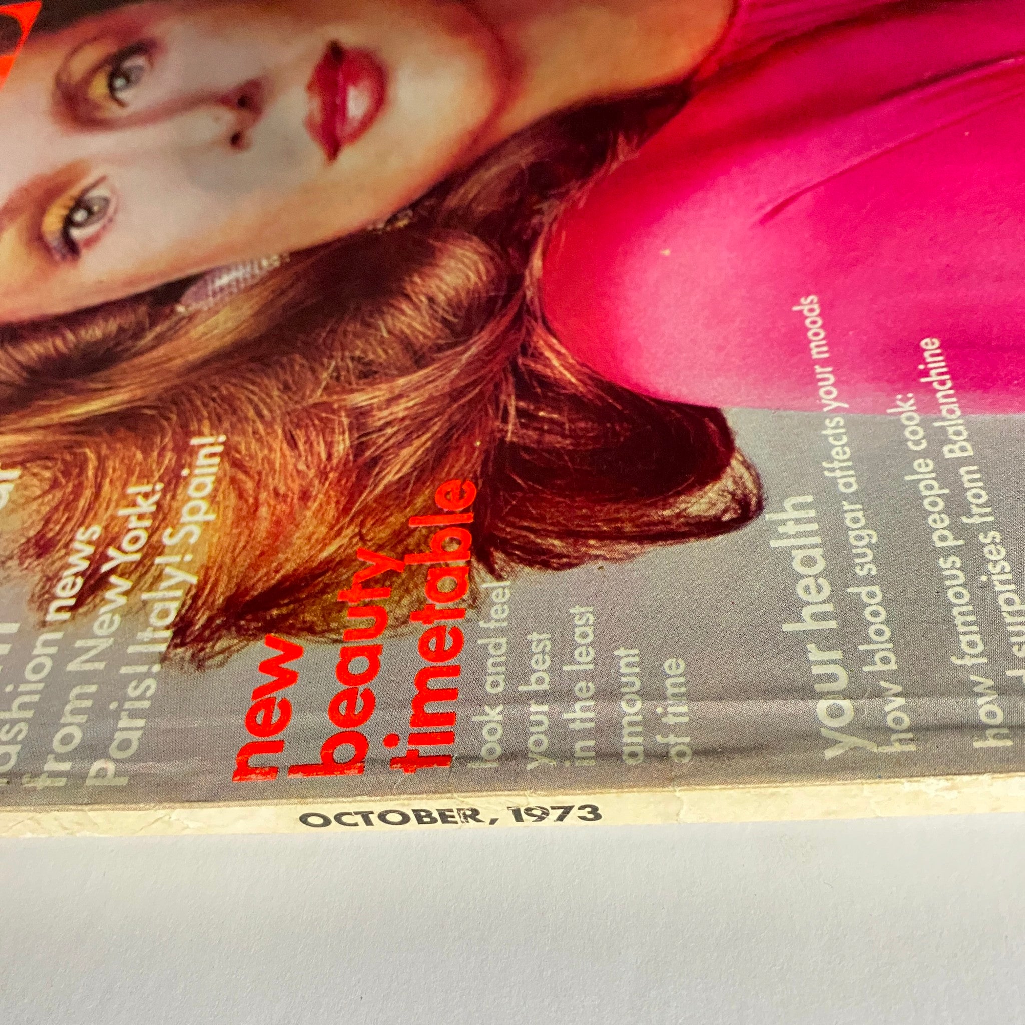 Side view of Vogue Magazine October 1973 Lauren Hutton Cover emphasizing the magazine's title and features from the 1973 issue.