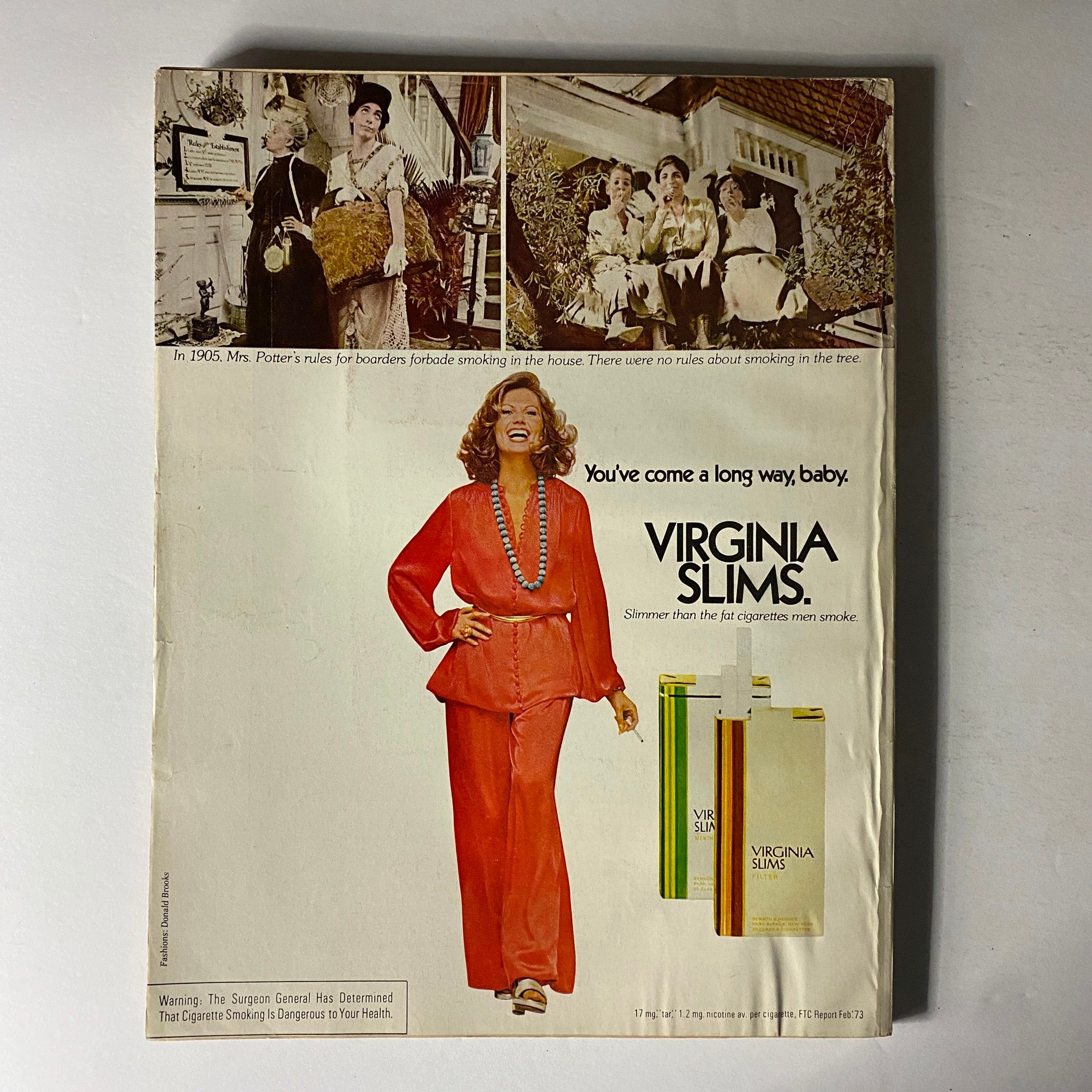Vintage advertisement from Vogue Magazine October 1973 featuring a model in a striking red outfit with a playful pose. The ad reads 'You've come a long way, baby. VIRGINIA SLIMS.' This image captures the essence of 1970s fashion and culture as showcased in the magazine, which features Lauren Hutton on the cover.