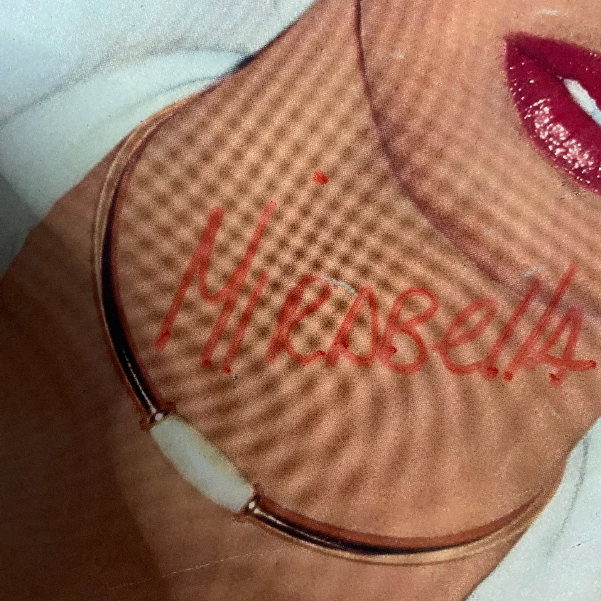 Close-up of the cover of Vogue Paris Magazine May 1975 with a handwritten note saying 'Mirabella' on the model's neck, revealing vintage fashion details.