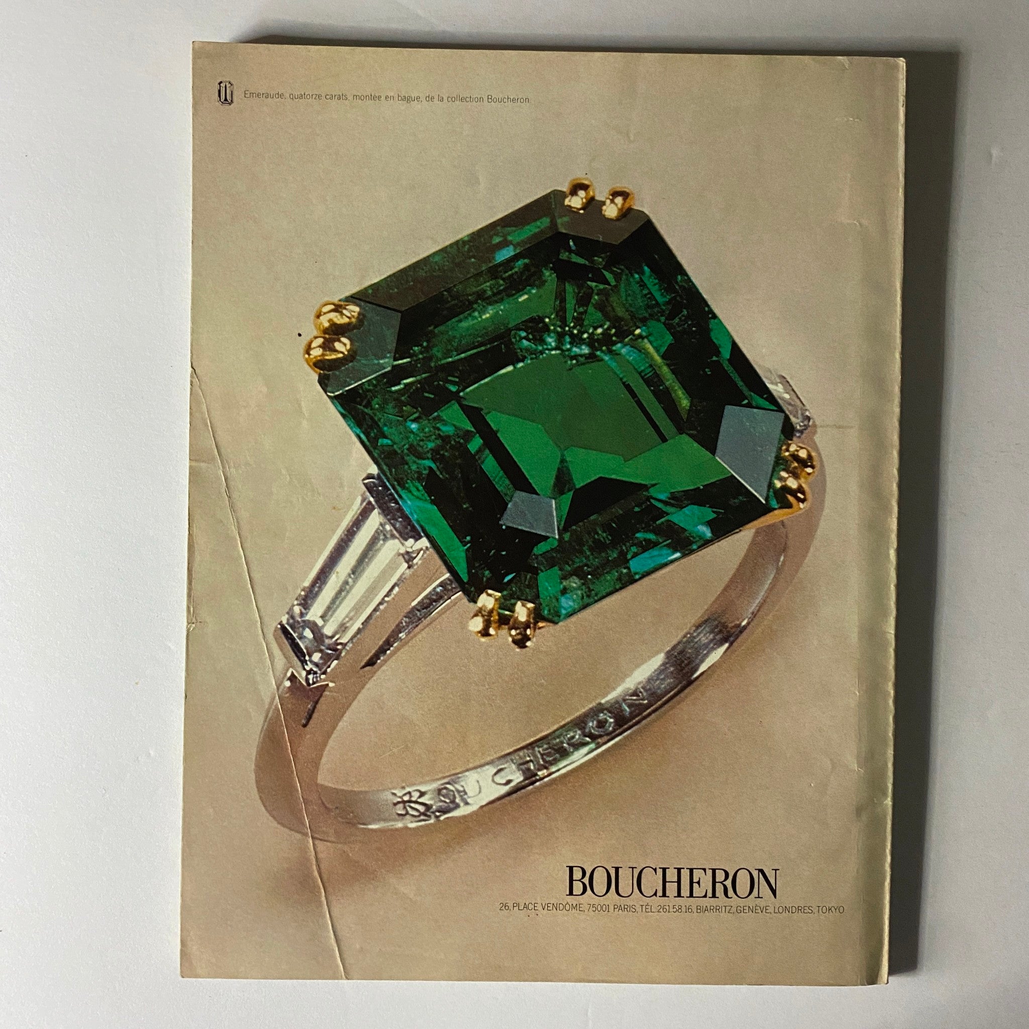 Vogue Paris Magazine May 1975 featuring a luxurious Boucheron ring with a large green gemstone and intricate design. This image showcases the elegance of vintage jewelry fashion as seen in high-end magazines of the 1970s.