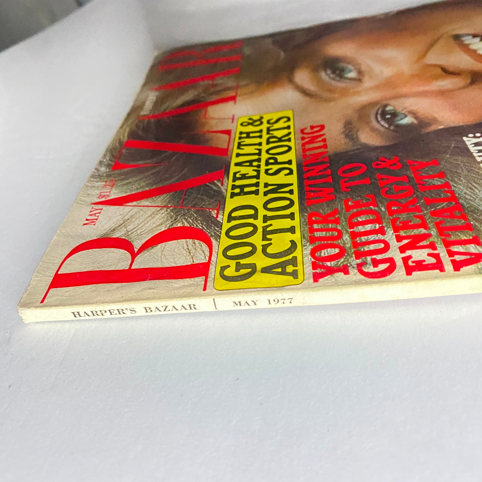 Side view of Harper's Bazaar Magazine May 1977 showing the title and month of publication, emphasizing its vintage condition.