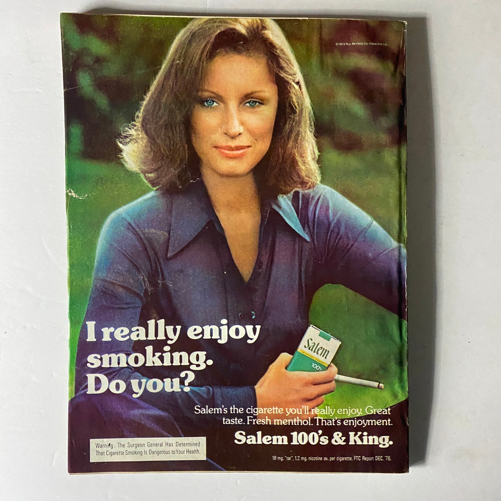 Vintage advertisement from Harper's Bazaar November 1977 featuring a woman promoting Salem cigarettes, presenting a casual lifestyle message related to smoking, framed by a retro aesthetic.