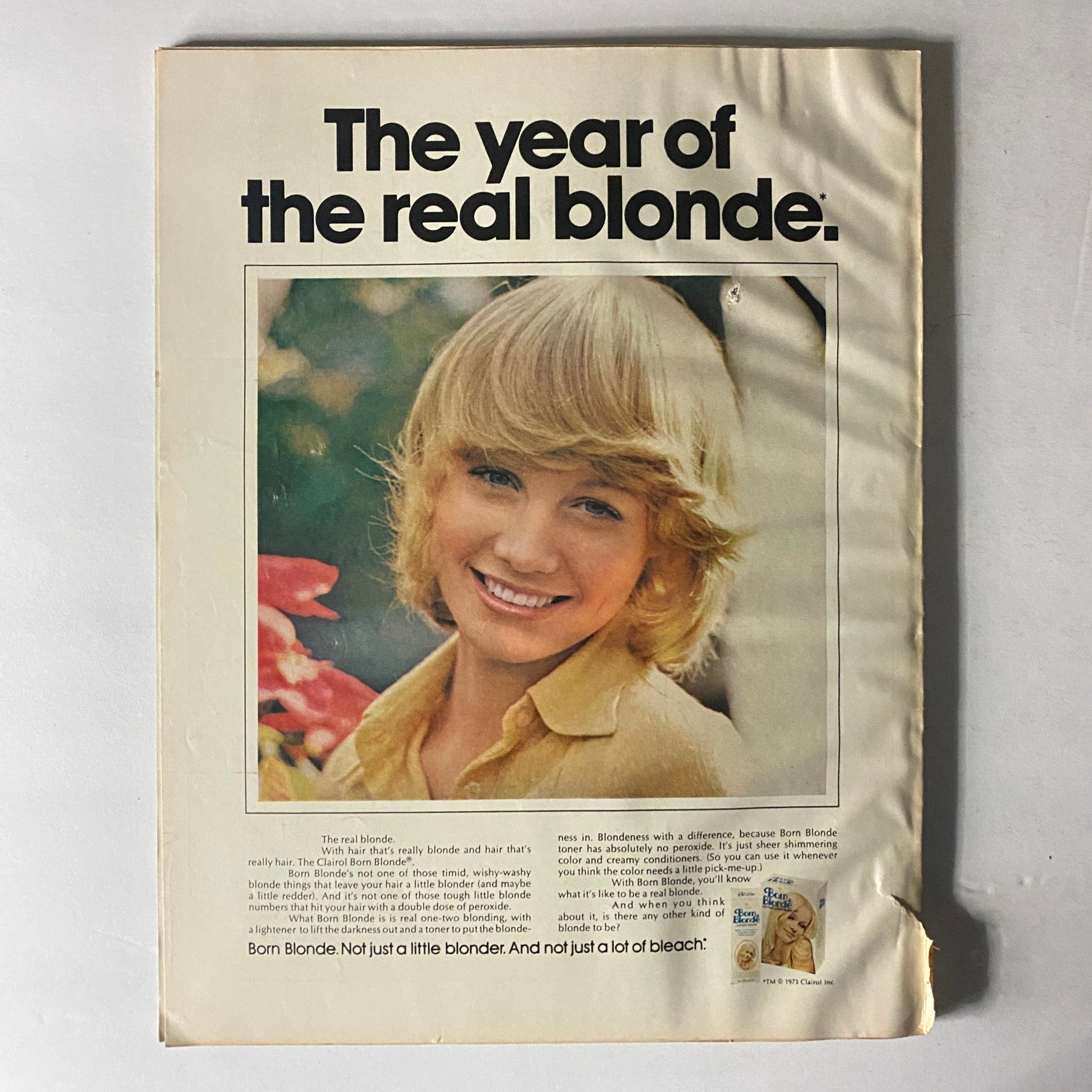 Back cover of Harper's Bazaar Magazine, May 1973, featuring an advertisement titled 'The year of the real blonde,' promoting a hair product for the vintage market.