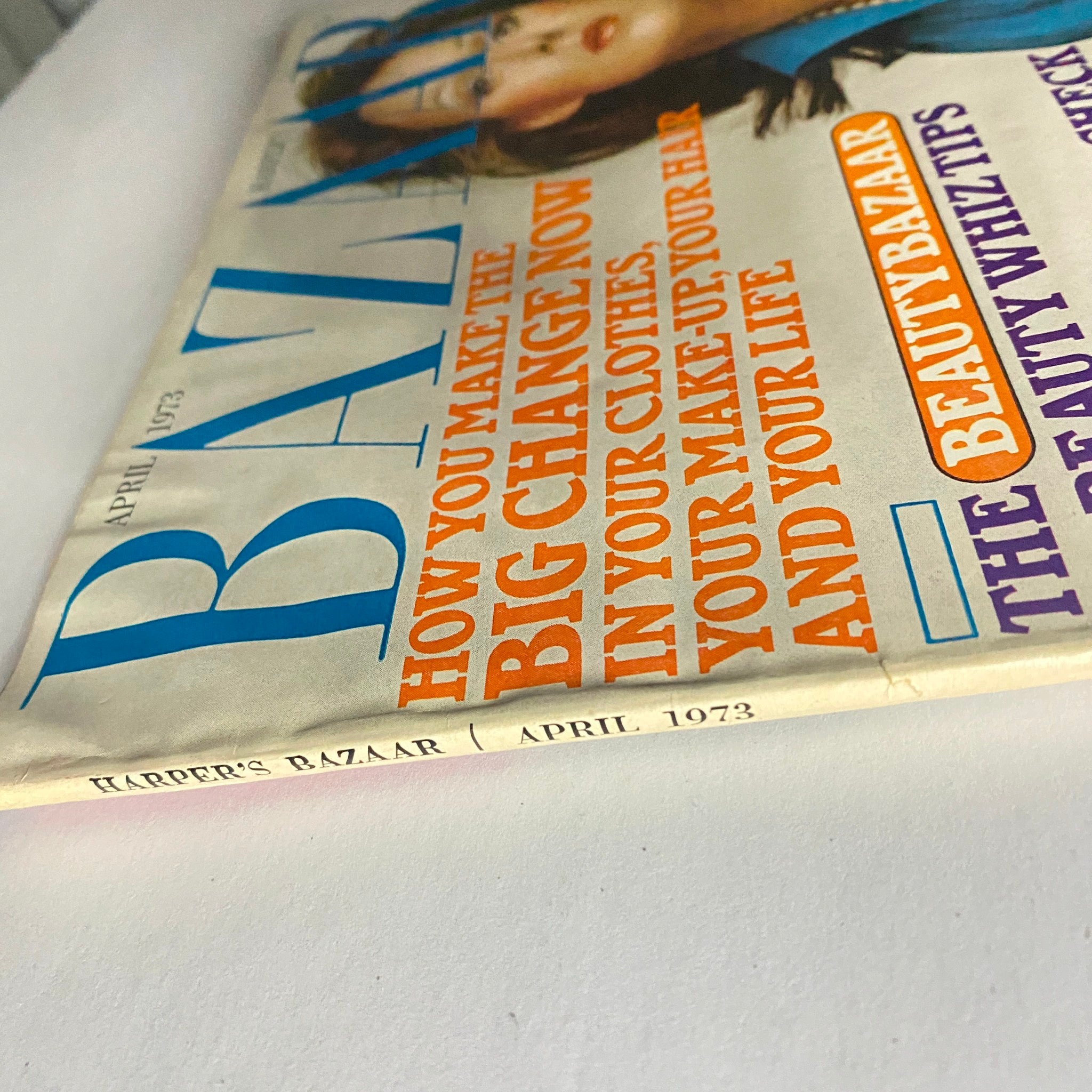 Side view of the cover page of Harper's Bazaar Magazine April 1973, highlighting the title and key articles for the issue.