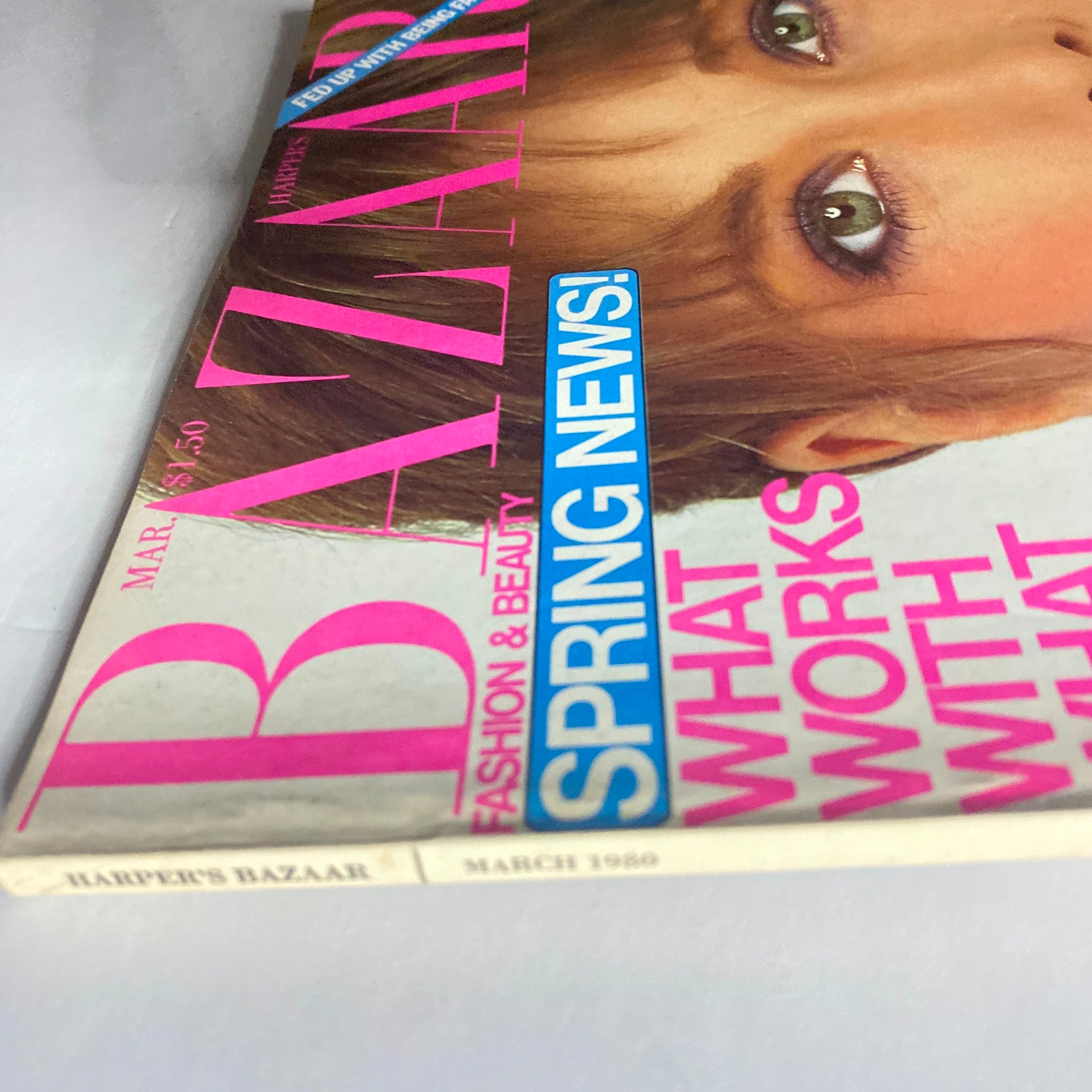 Harper's Bazaar Magazine March 1980 cover featuring striking pink typography and a model's captivating gaze, showcasing the fashion and beauty of the era.
