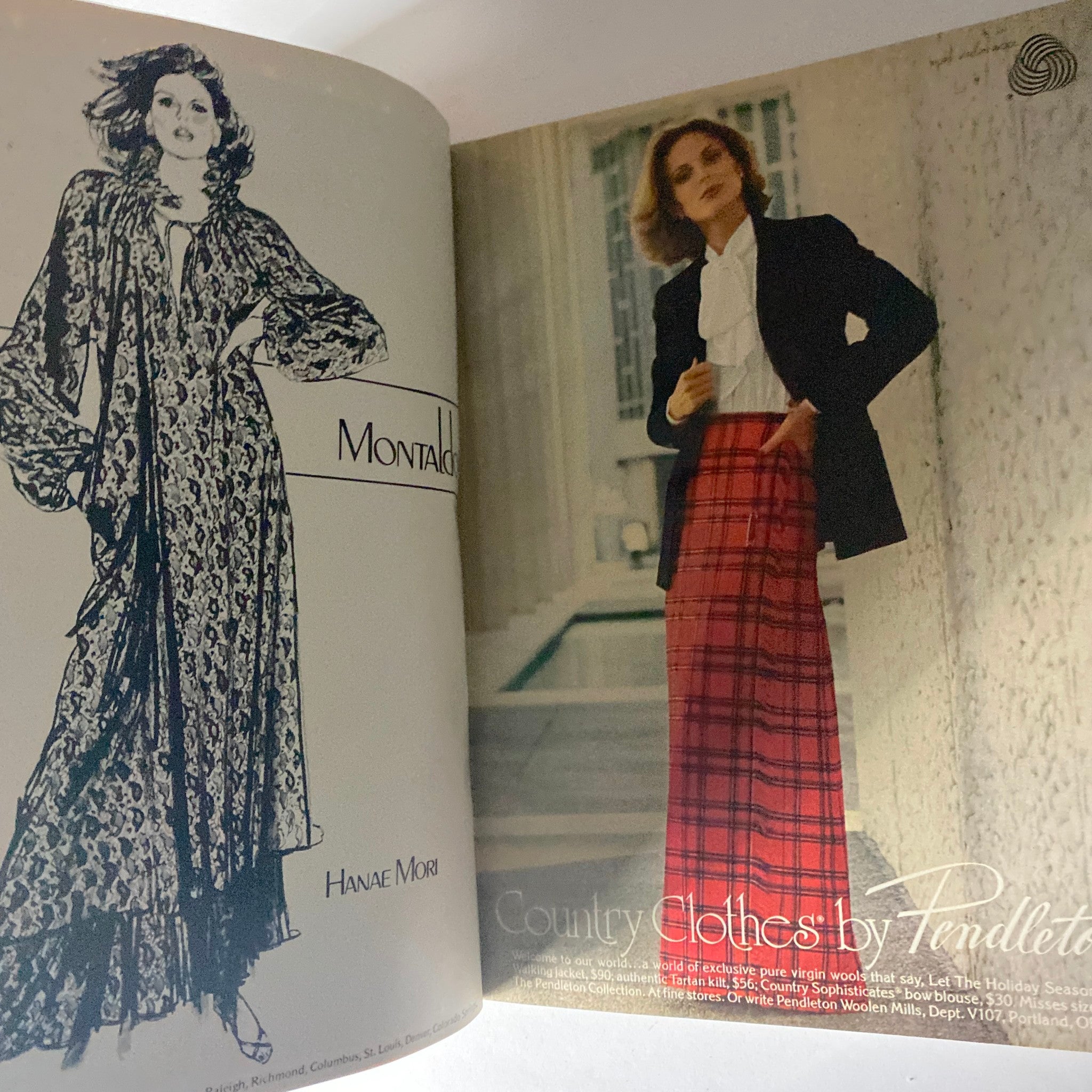 Inside view of Harper's Bazaar Magazine October 1977, featuring fashion advertising for Hanae Mori with a model in a stylish, flowing robe and another model in a tailored blazer and plaid skirt.