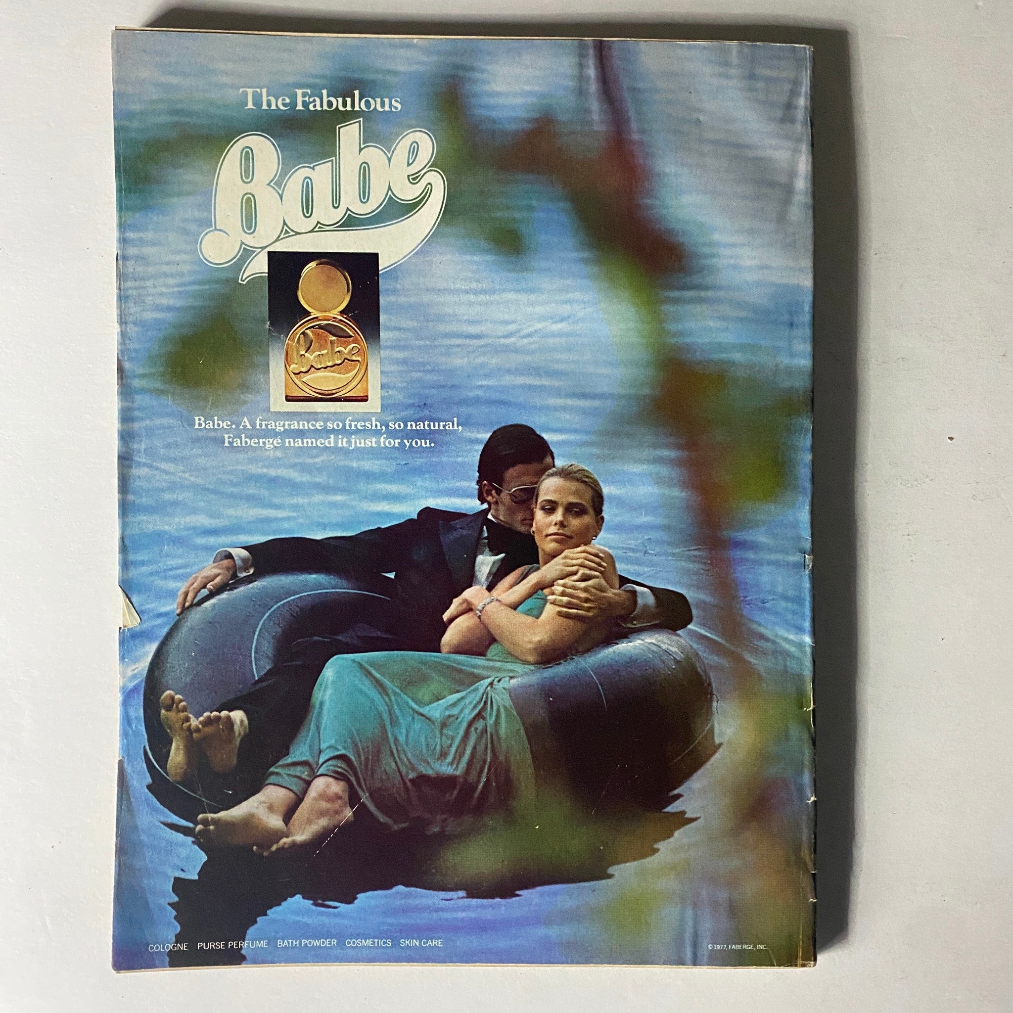Harper's Bazaar Magazine May 1978 Cheryl Tiegs Cover showing an advertisement for Babe fragrance with a couple relaxing in a serene water setting.