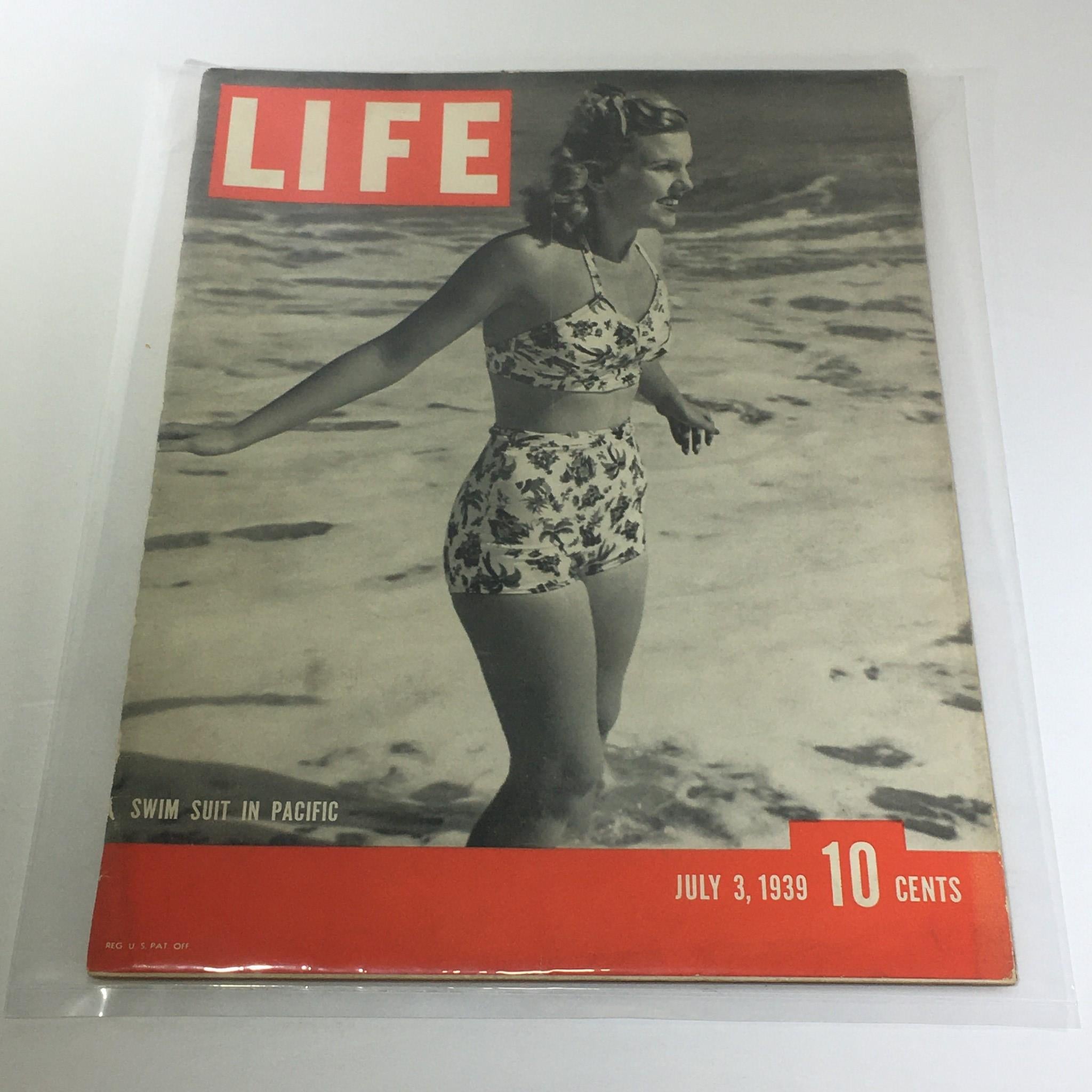 Vintage Life Magazine cover from July 3, 1939, featuring a woman in a floral swim suit by the ocean, titled 'Swim Suit In Pacific.' This historical magazine highlights leisure and fashion from the late 1930s.