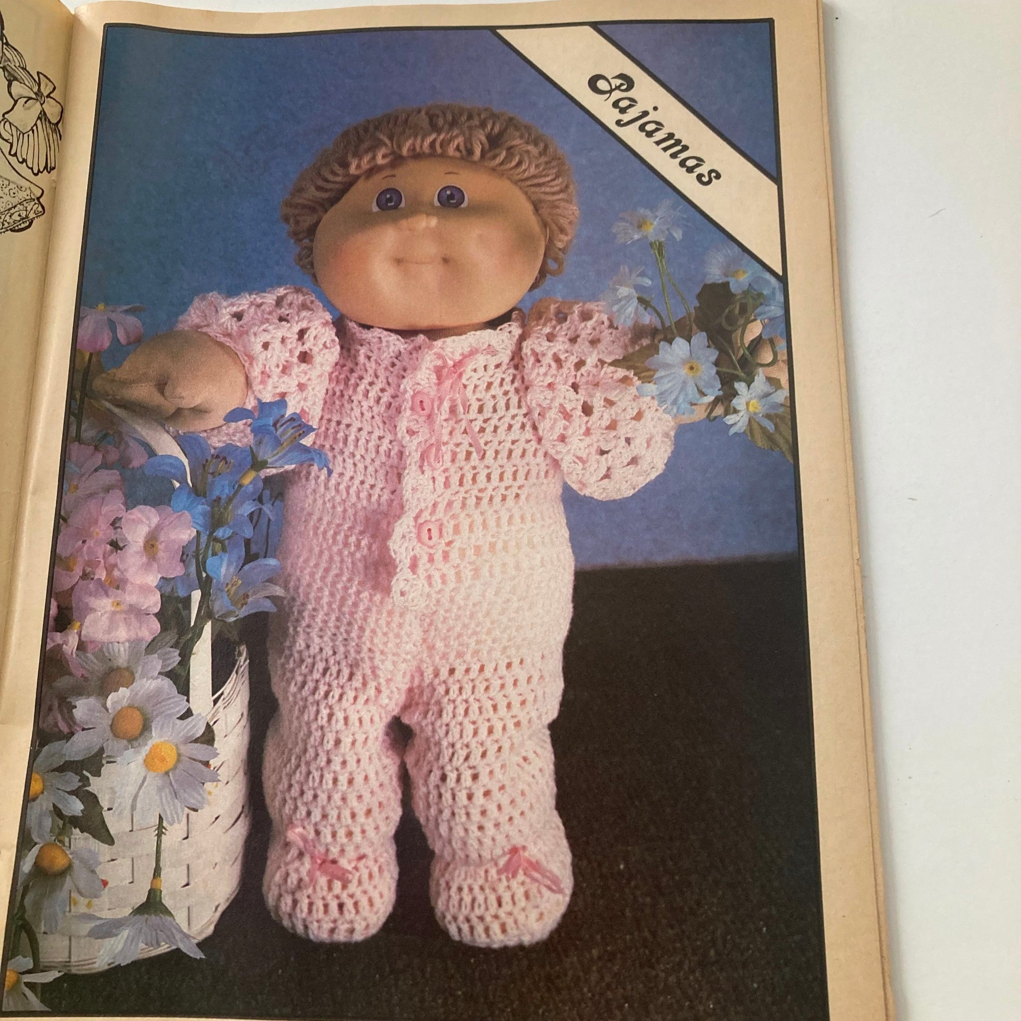 A page from VTG Doll World Magazine 1985 #2 featuring a doll in pink pajamas, showcasing the summer wardrobe theme for adopted kids.