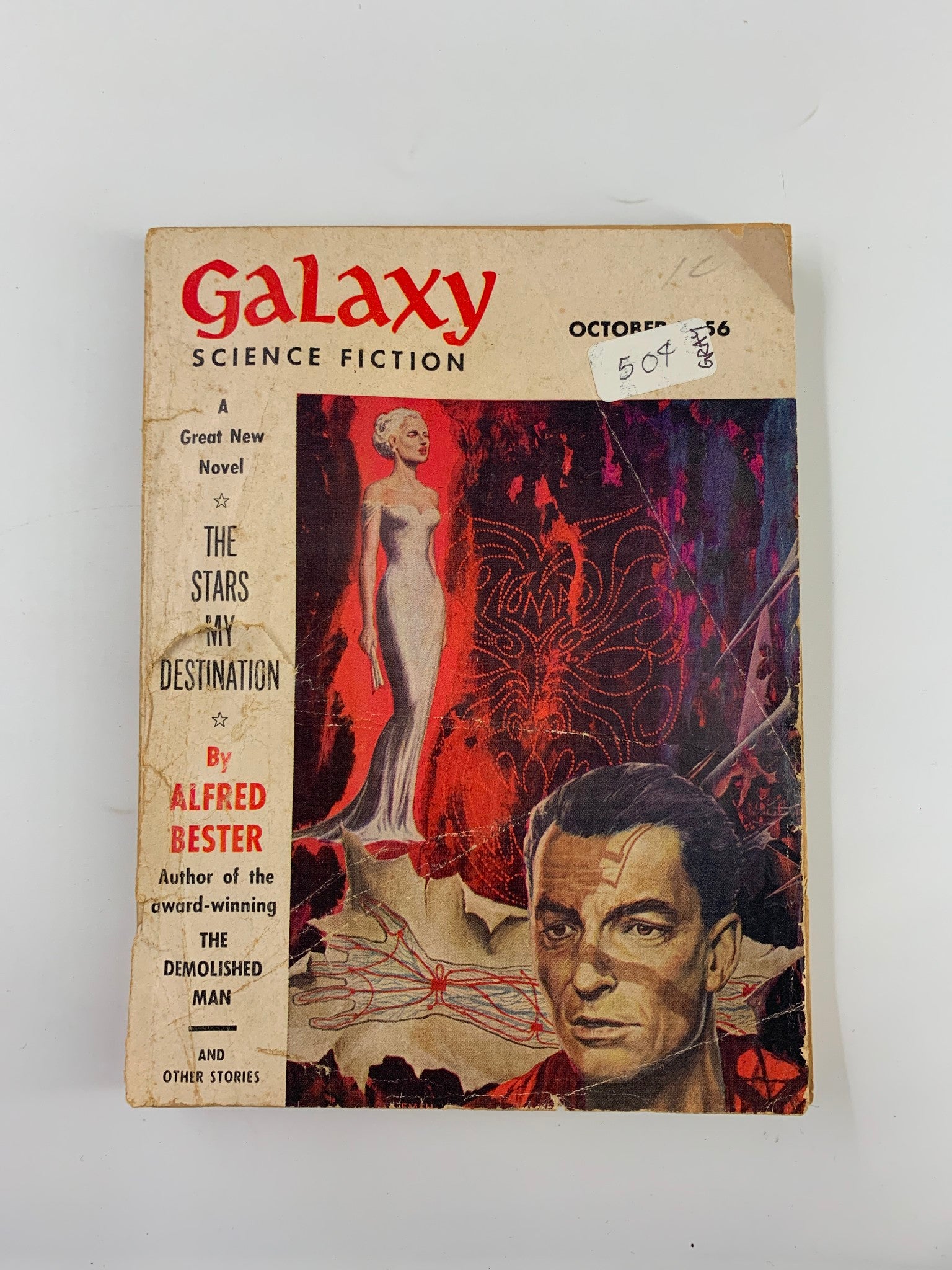 Cover of Galaxy Science Fiction Magazine, October 1956, featuring the title 'The Stars in My Destination' by Alfred Bester. The magazine showcases vibrant artwork of a woman in a dress and a man, reflecting the science fiction theme of the era.