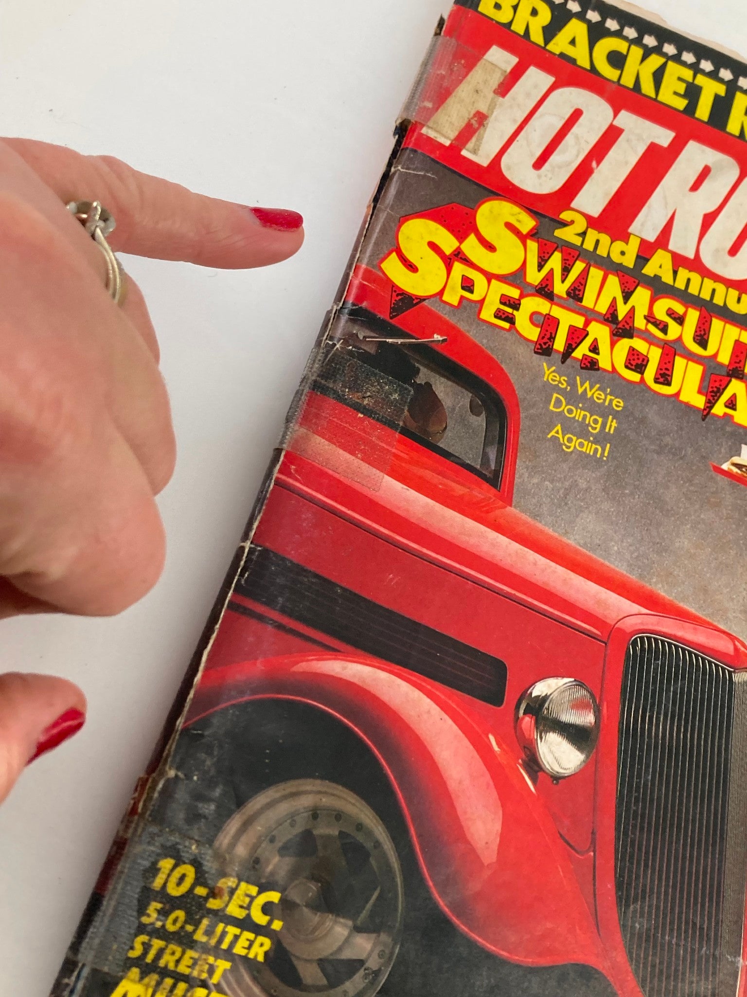Close-up view of the Hot Rod Magazine April 1988 Vol 41 #4 showing wear and tear with visible creases and a taped binding, capturing the vintage feel of this collectible automotive magazine.