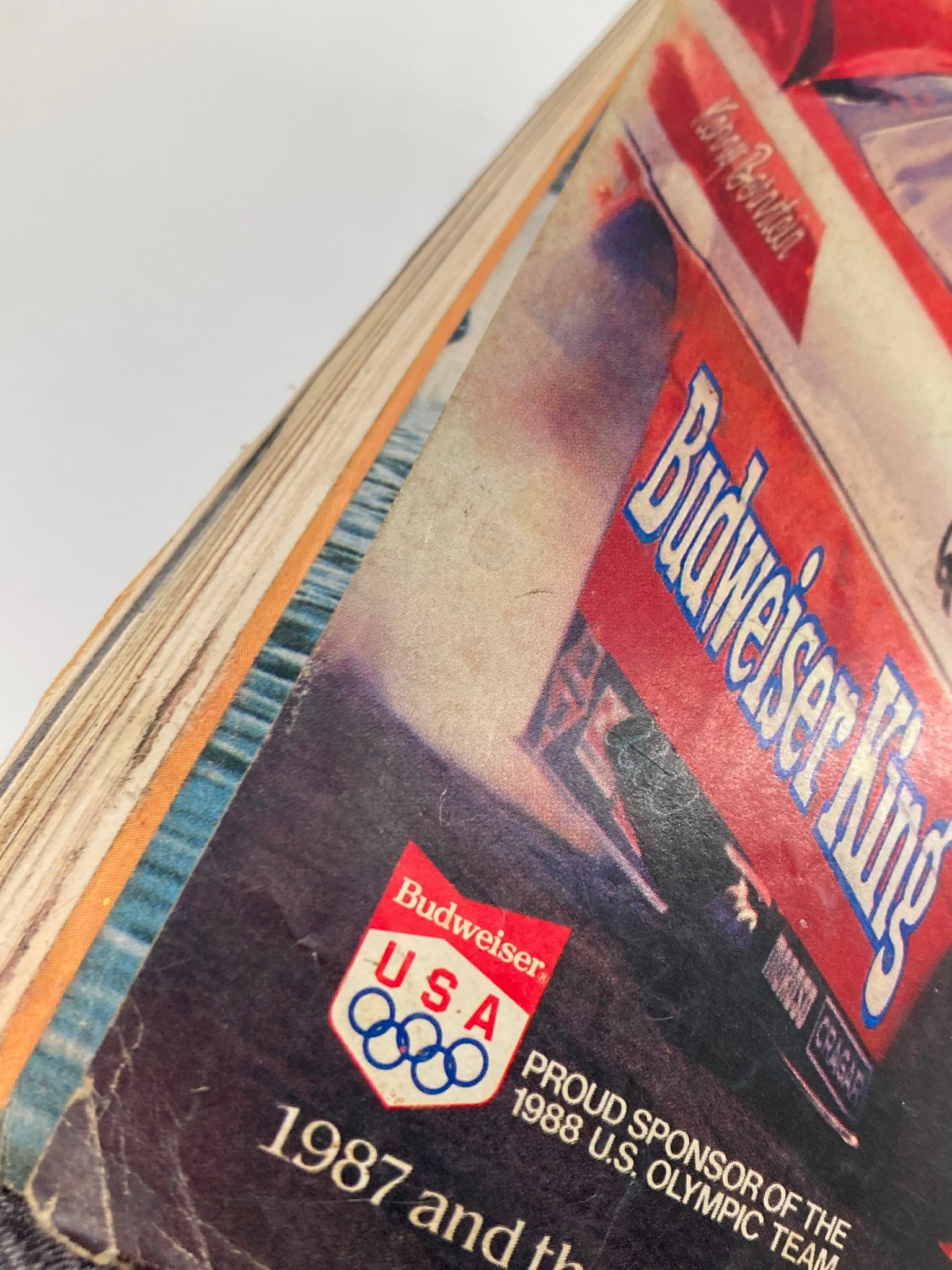 Side view of the spine of VTG Hot Rod Magazine April 1988 Vol 41 #4 showcasing classic Budweiser branding and Olympic sponsorship.