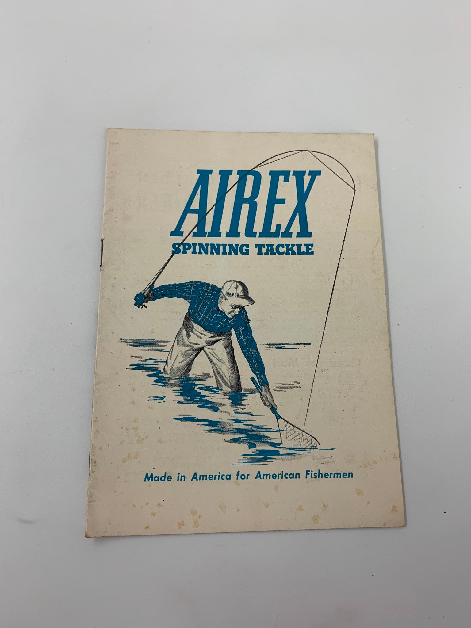 Cover of Airex Spinning Tackle magazine, showcasing a fisherman using a net with the title 'Airex Spinning Tackle Made in America for American Fishermen' highlighted.