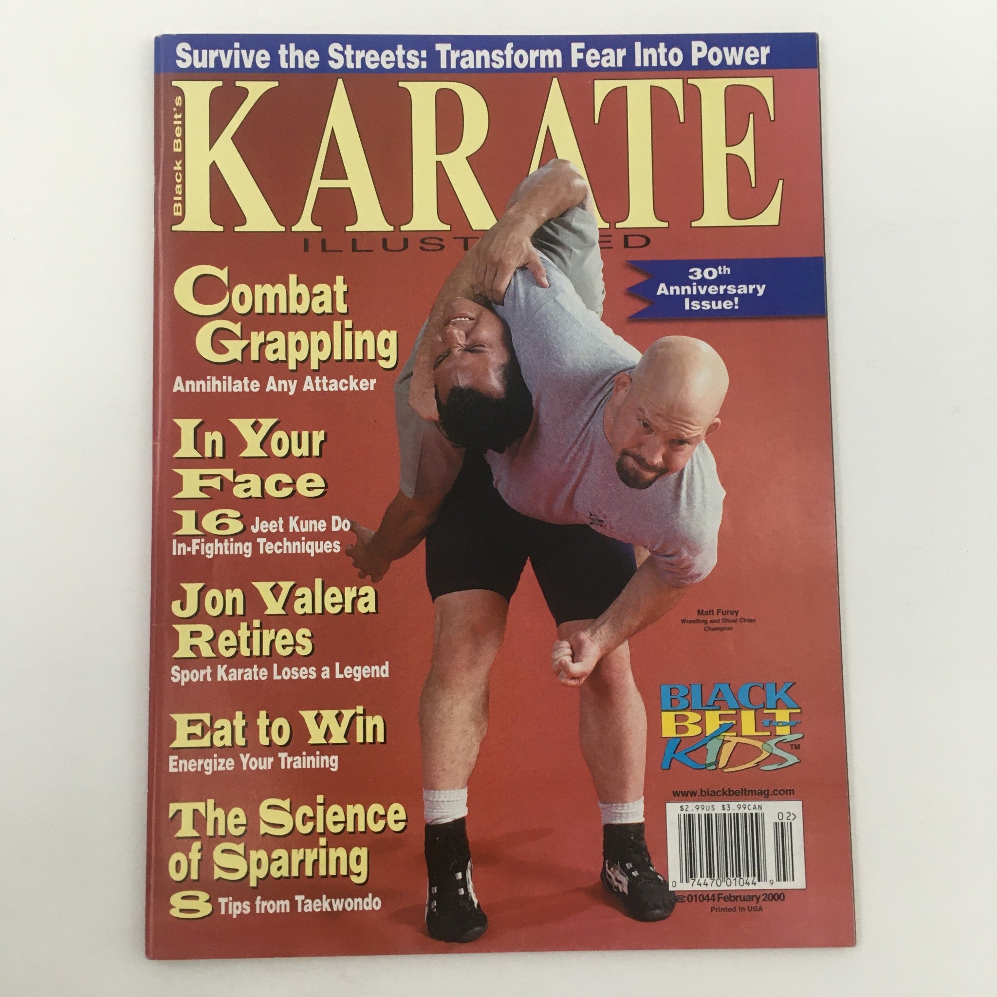 Cover of Karate Illustrated Magazine February 2000 featuring Matt Furey, a Shuai Chiao champion. The magazine showcases martial arts themes including combat grappling and self-defense techniques, celebrating its 30th Anniversary.