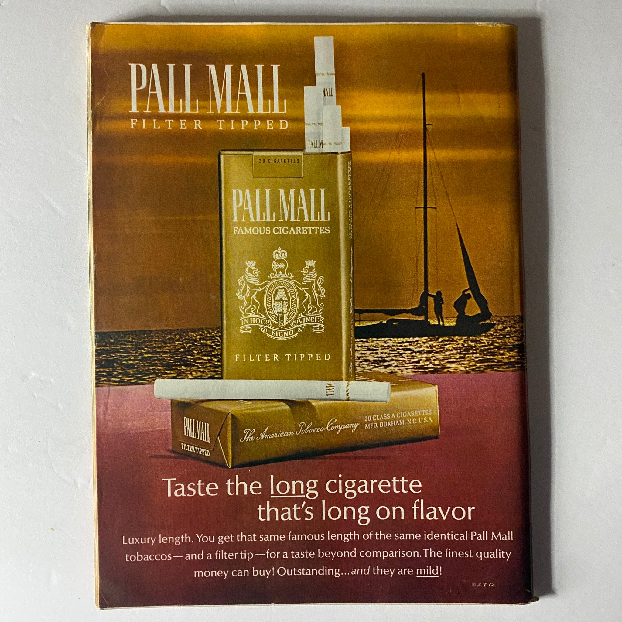 Vintage advertisement for Pall Mall Filter Tipped cigarettes, highlighting the slogan 'Taste the long cigarette that's long on flavor' with an aesthetic background.