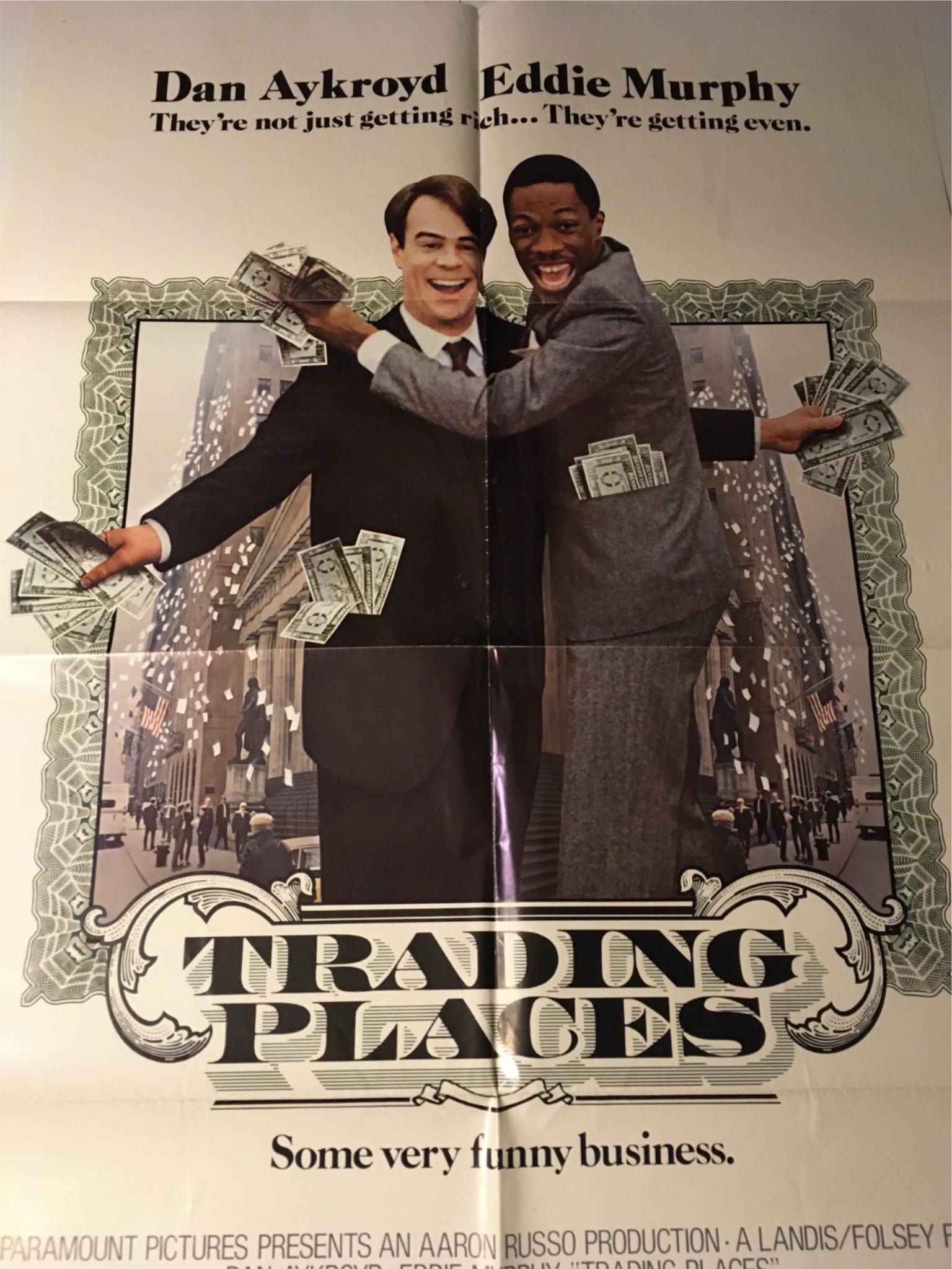 1983 Trading Places 41" x 27" Original Movie Poster illustrating Eddie Murphy and Dan Aykroyd in a lighthearted pose with money amid a city setting.