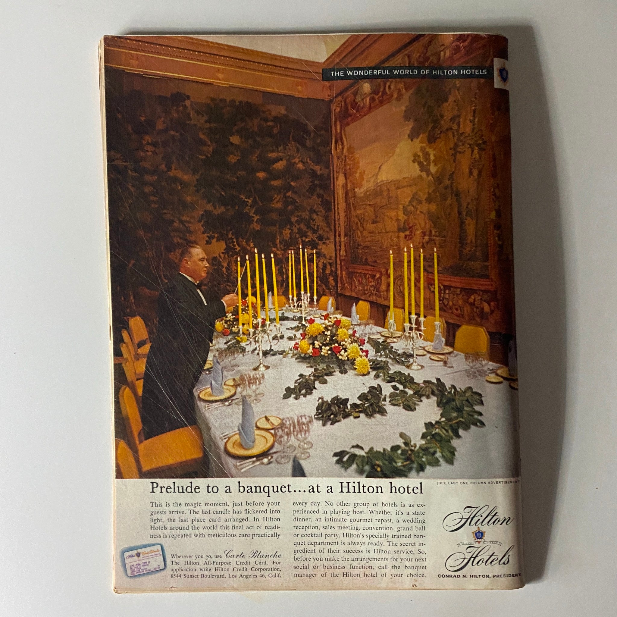 Back cover of the Time Magazine March 21, 1960, Vol 75 No. 12, with a vintage advertisement for Hilton Hotels, highlighting the era's marketing style.