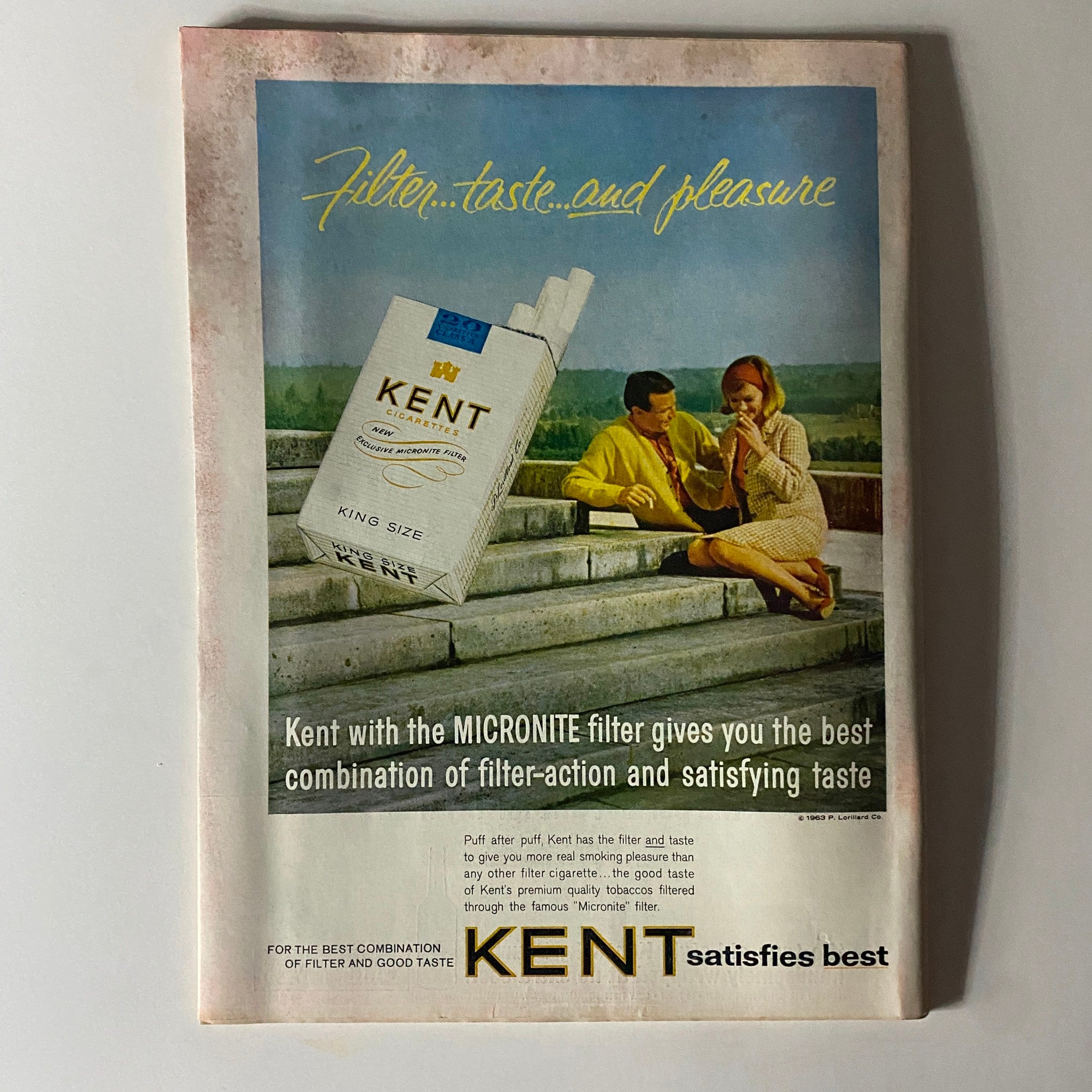 Vintage advertisement for Kent cigarettes featuring a couple enjoying a moment together, with a King Size Kent pack prominently displayed. Part of Time Magazine November 8, 1963, Vol 82 No. 19.