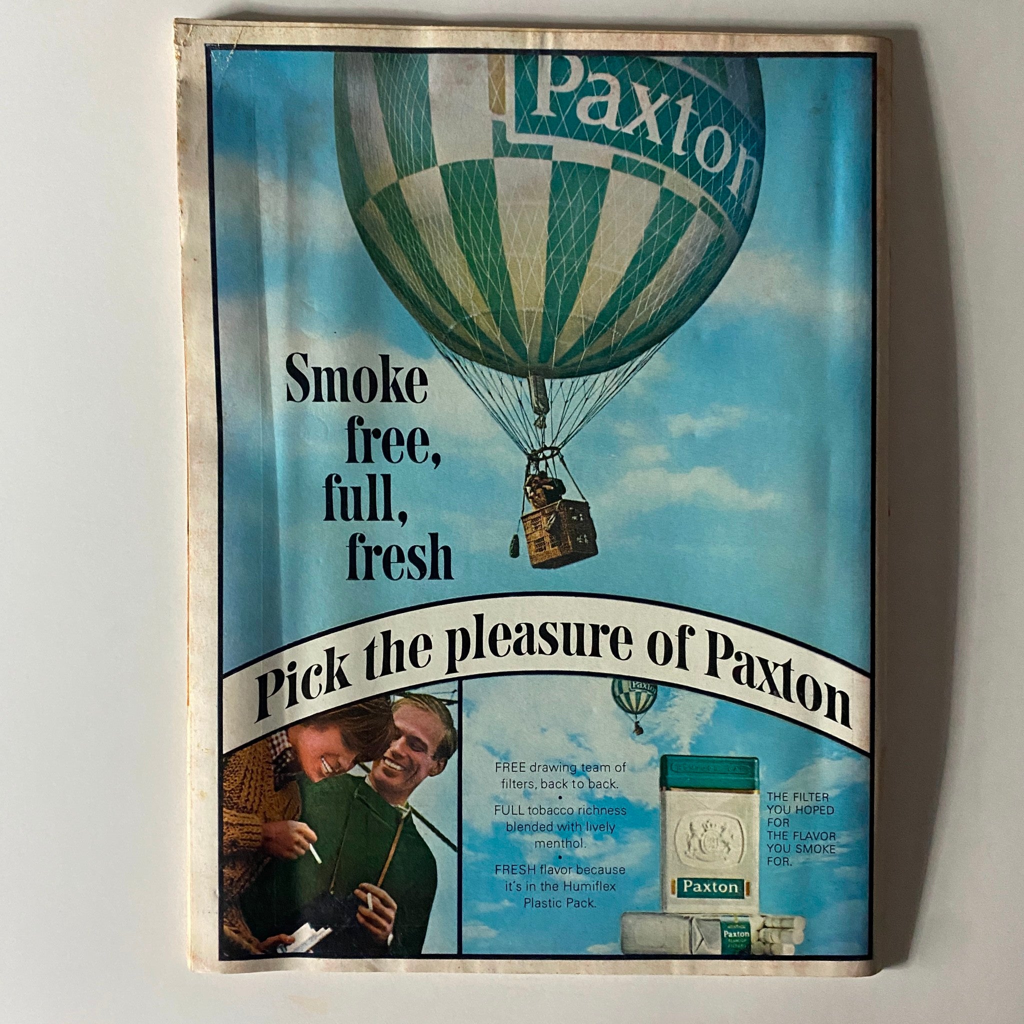 Back cover of a vintage advertisement for Paxton cigarettes featuring a colorful hot air balloon and the slogan 'Smoke free, full, fresh'. This ad captures the marketing style of the 1960s.