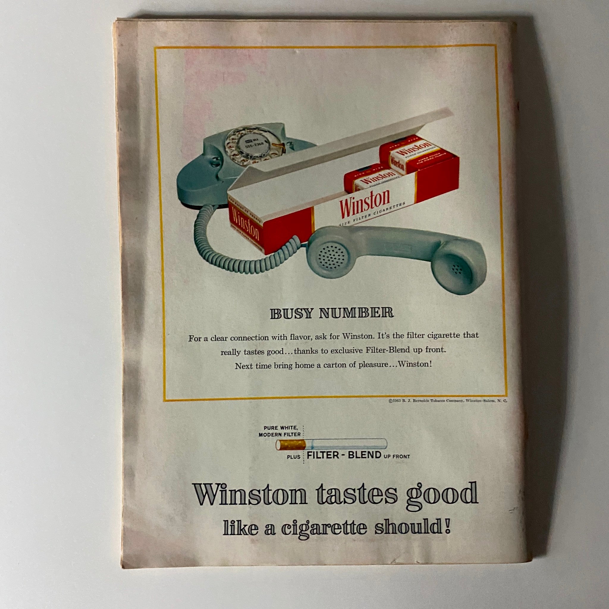 Back cover advertisement of Time Magazine, December 13, 1963, featuring a Winston cigarette ad highlighting a vintage telephone and box of cigarettes.