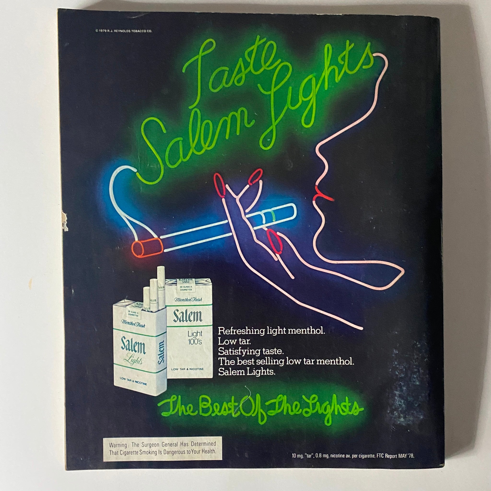 Cover of Harper's Bazaar Magazine from November 1979 featuring an advertisement for Salem Lights cigarettes, showcasing neon graphics and a stylized hand holding a cigarette, emphasizing the fashion and culture of the 1970s.