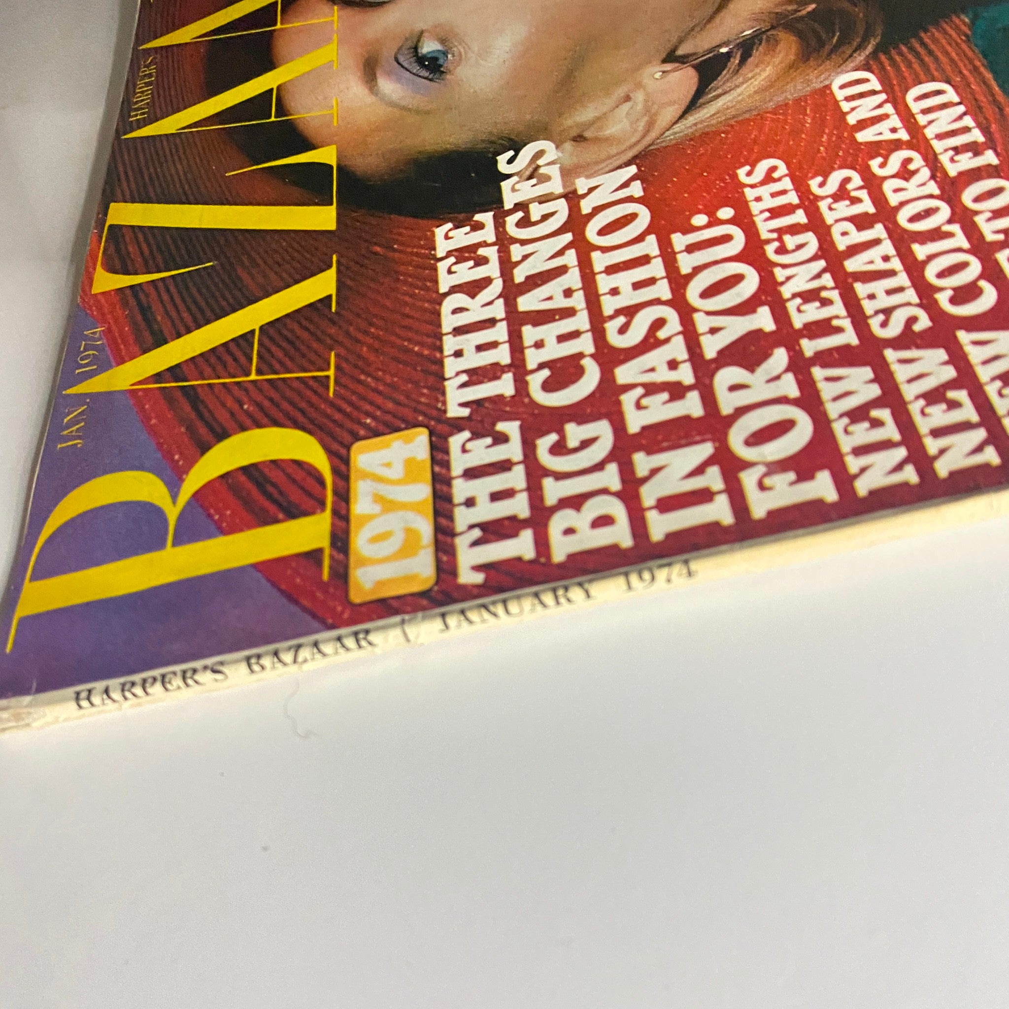Side view of the spine of Harper's Bazaar Magazine January 1974 displaying the publication title and highlighting key fashion changes.