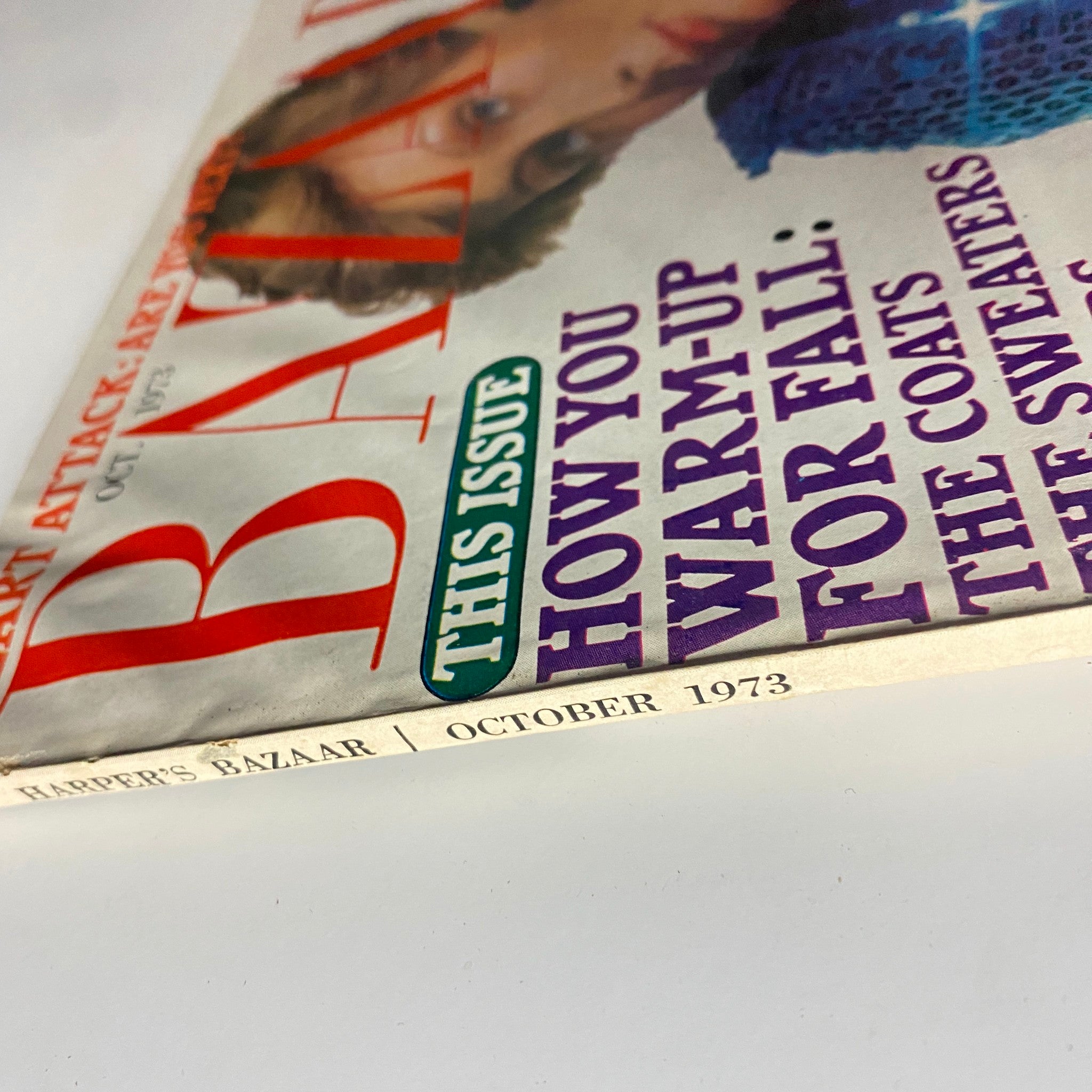 Side view of Harper's Bazaar Magazine October 1973 displaying the magazine title and publication date, highlighting its vintage appeal.