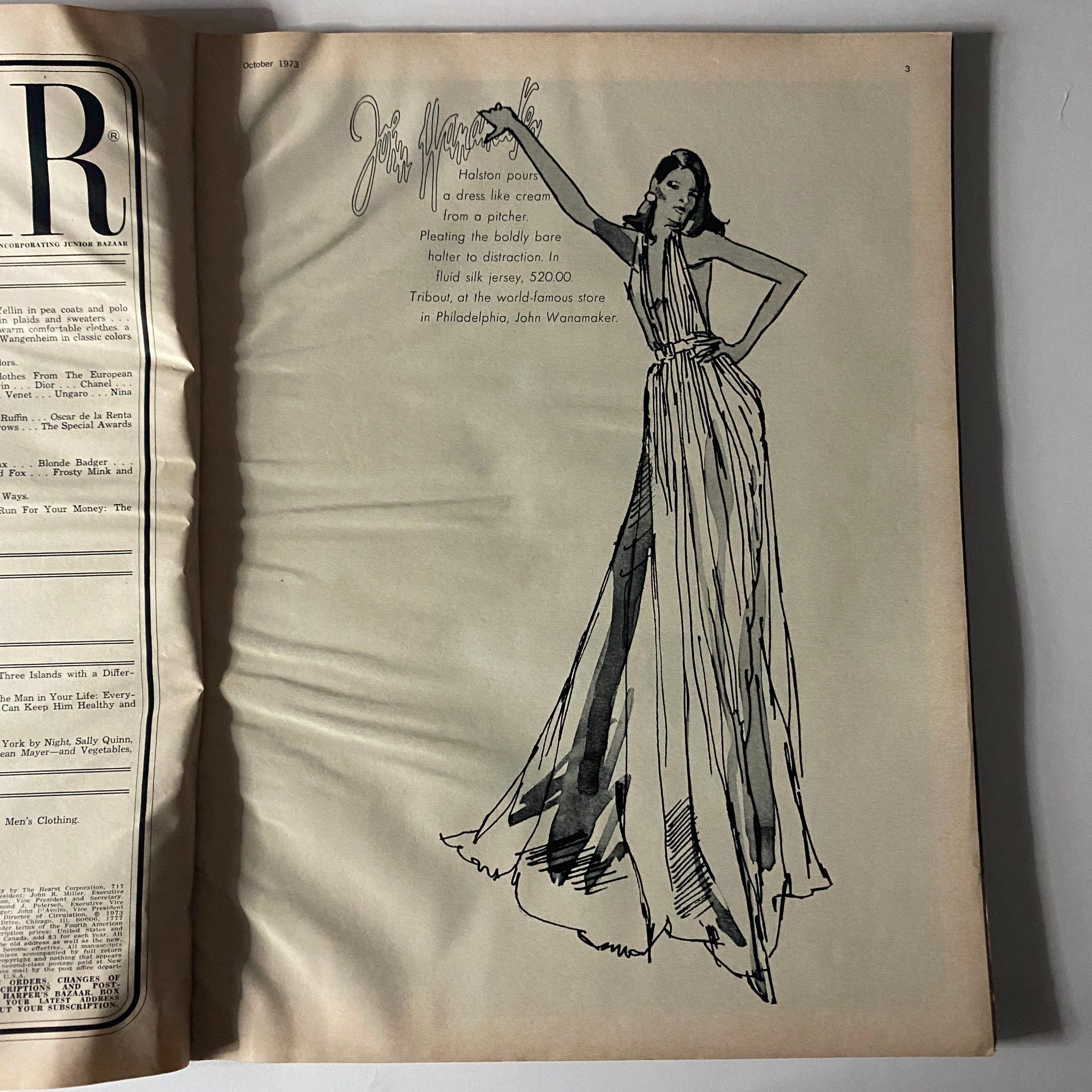 Artwork page from Harper's Bazaar Magazine October 1973 illustrating a Halston dress, emphasizing the fashion illustrations of the 1970s.