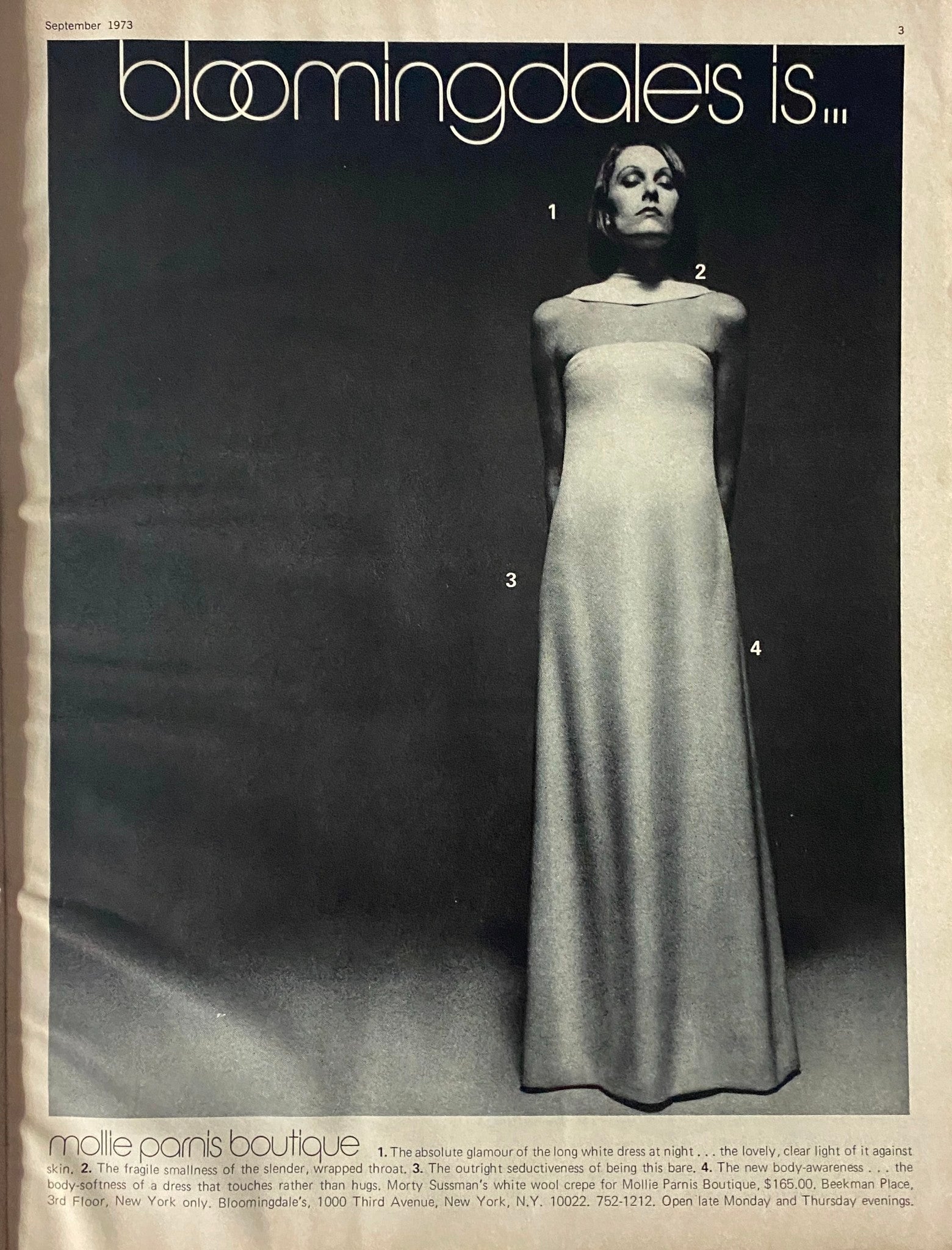Black and white fashion advertisement within Harper's Bazaar Magazine September 1973, featuring a model in a minimalist dress, indicative of the fashion aesthetics of the era.