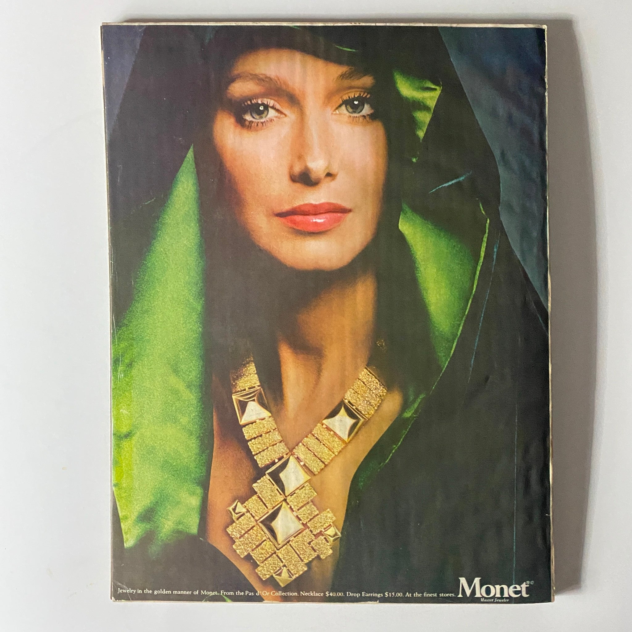 Back cover of Harper's Bazaar Magazine September 1973 showcasing a striking jewelry advertisement for Monet, illustrating the jewelry trends of the 1970s.