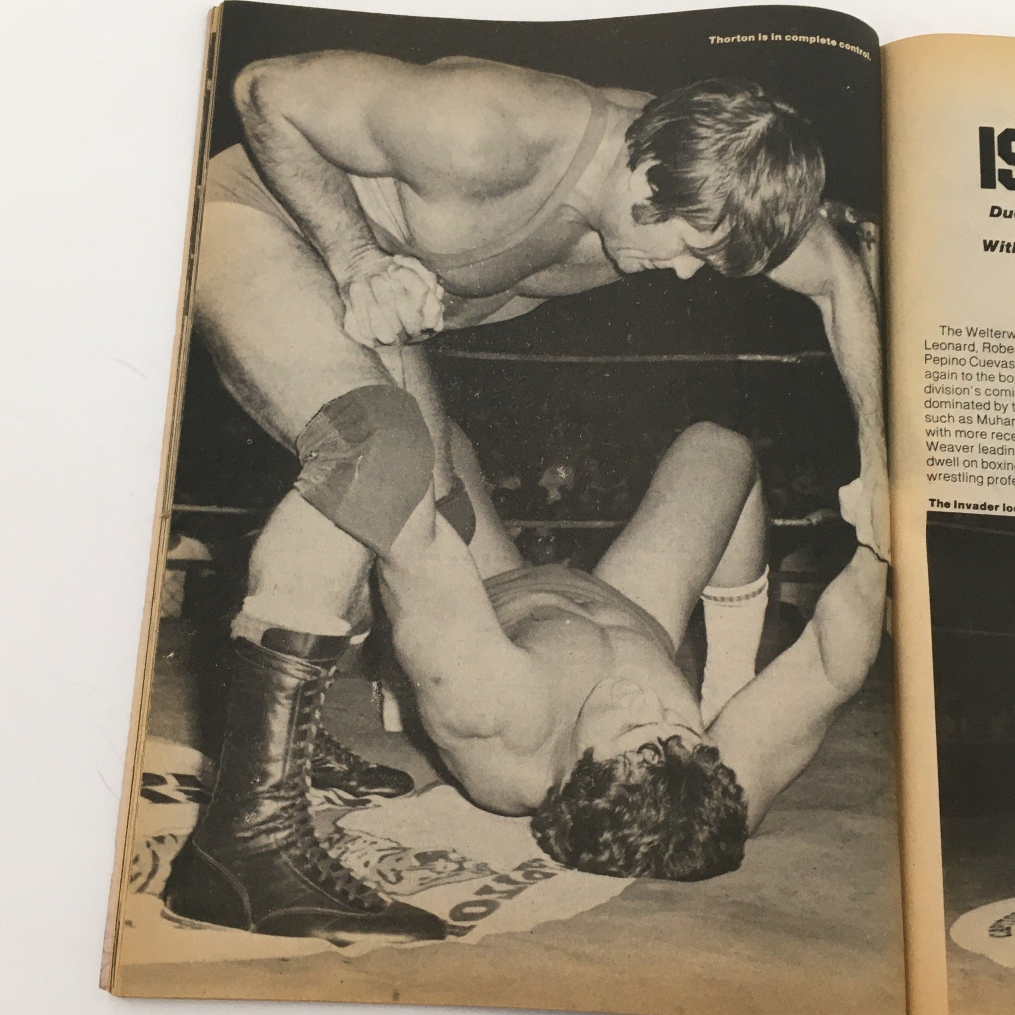 Black and white image from Wrestling Today Magazine, January 1981 showing wrestlers in a grappling match, highlighting the intense action of professional wrestling.