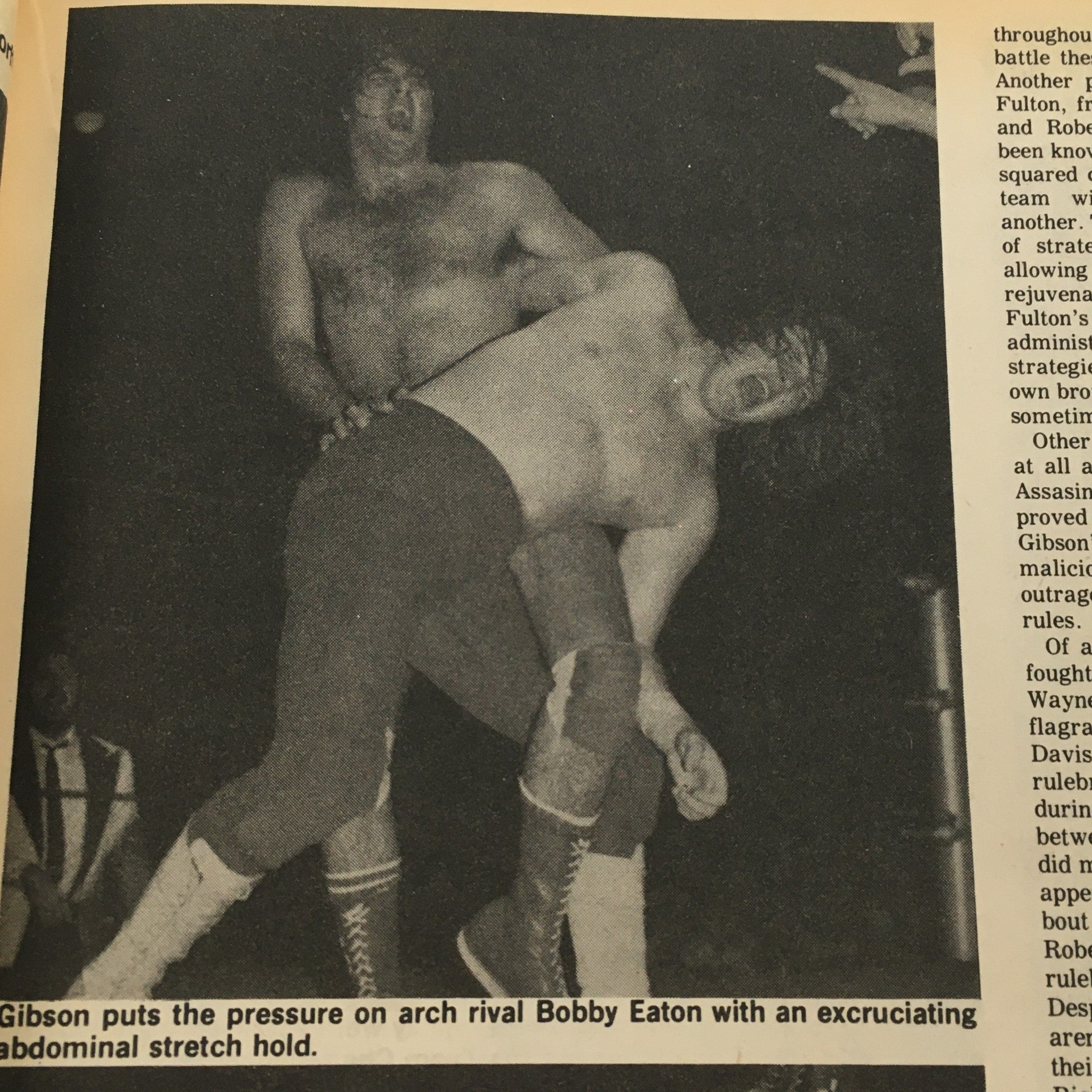 Action shot from The Ring's Wrestling Magazine December-January 1982 #78 featuring Gibson applying pressure on Bobby Eaton with an abdominal stretch hold, capturing a classic moment in professional wrestling history.