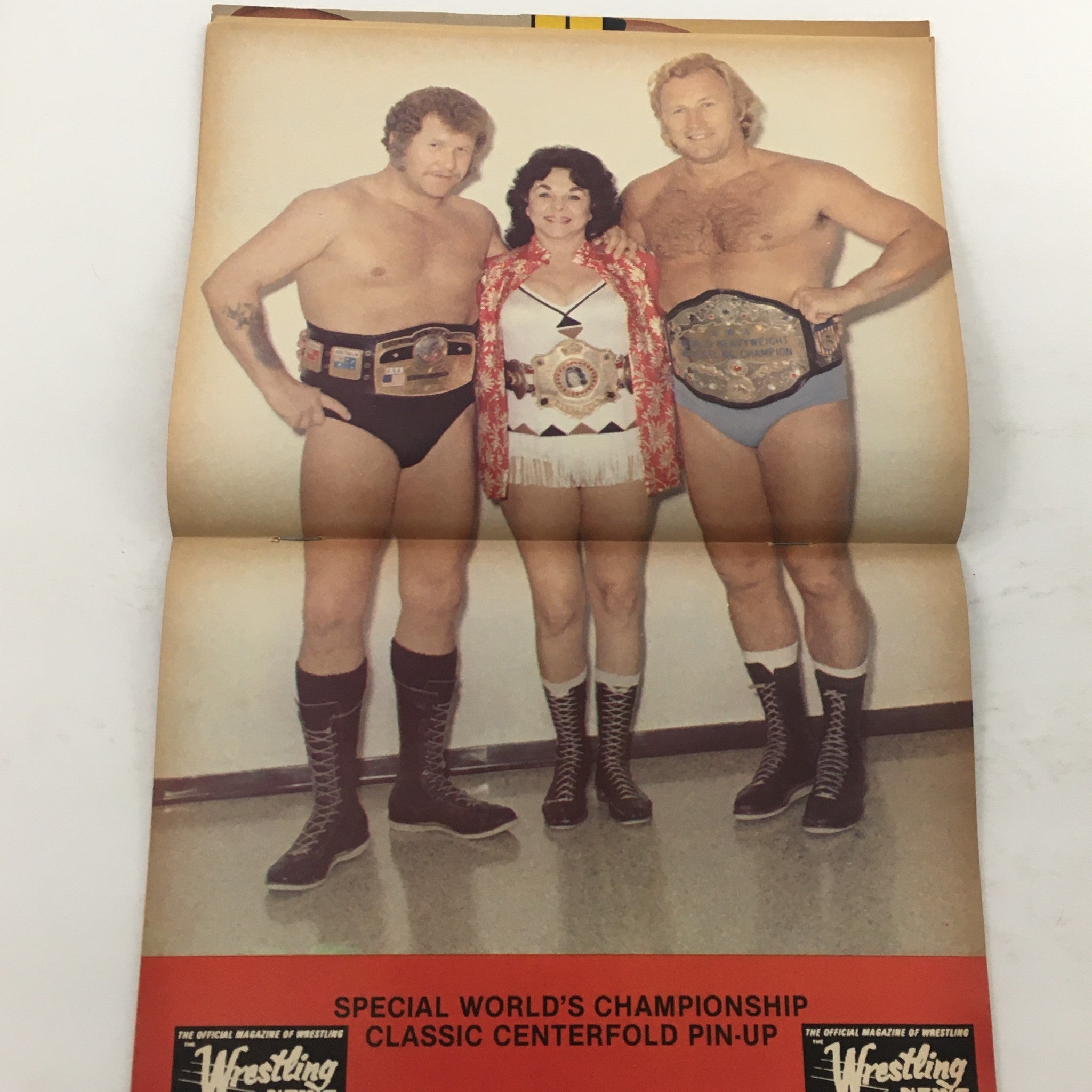 Centerfold pin-up from The Ring's Wrestling Magazine Issue #106 showcasing wrestlers with championship belts, celebrating wrestling's iconic moments and legends.