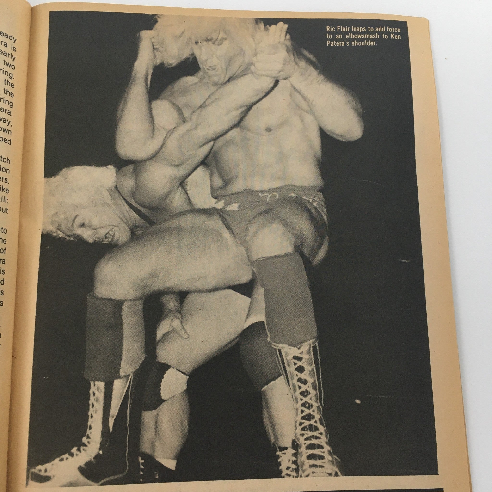 Action shot from 'The Wrestler Magazine' October 1981 depicting Ric Flair performing an elbow smash on Ken Patera during a wrestling match, illustrating classic wrestling techniques and maneuvers.