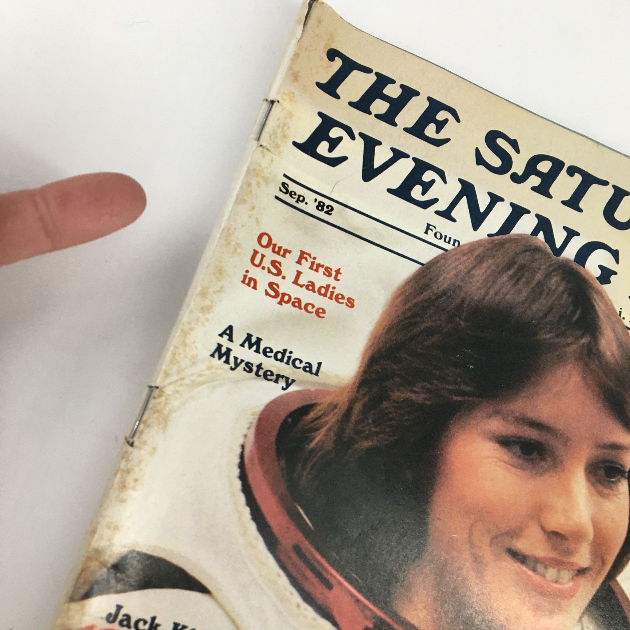 Close-up of the The Saturday Evening Post September 1982 magazine cover highlighting 'Our First U.S. Ladies in Space', with hands pointing at the title.