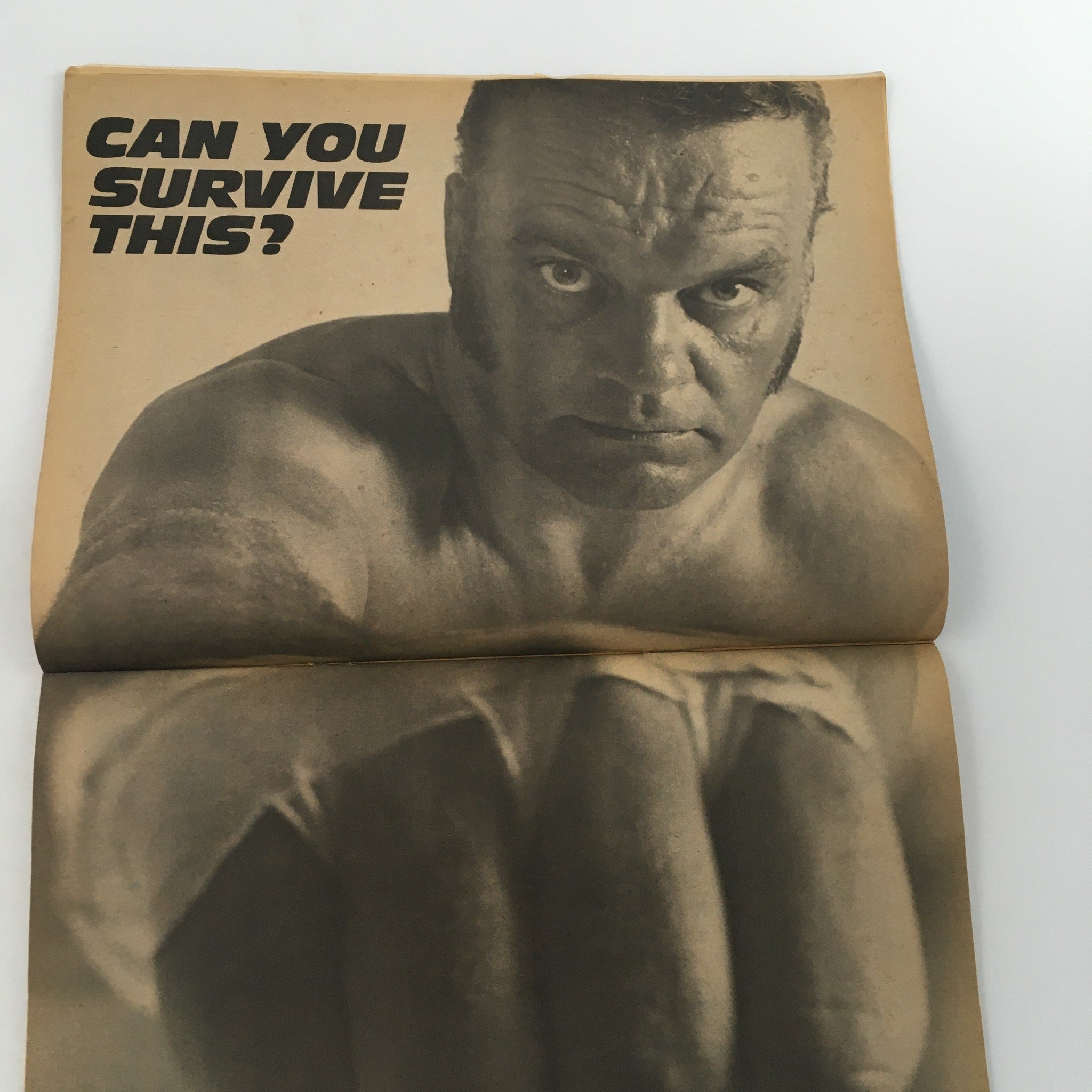 The Wrestler Magazine December 1977 featuring a dramatic black-and-white image of a wrestler with intense gaze and the bold text 'CAN YOU SURVIVE THIS?', highlighting the magazine's focus on wrestling culture.