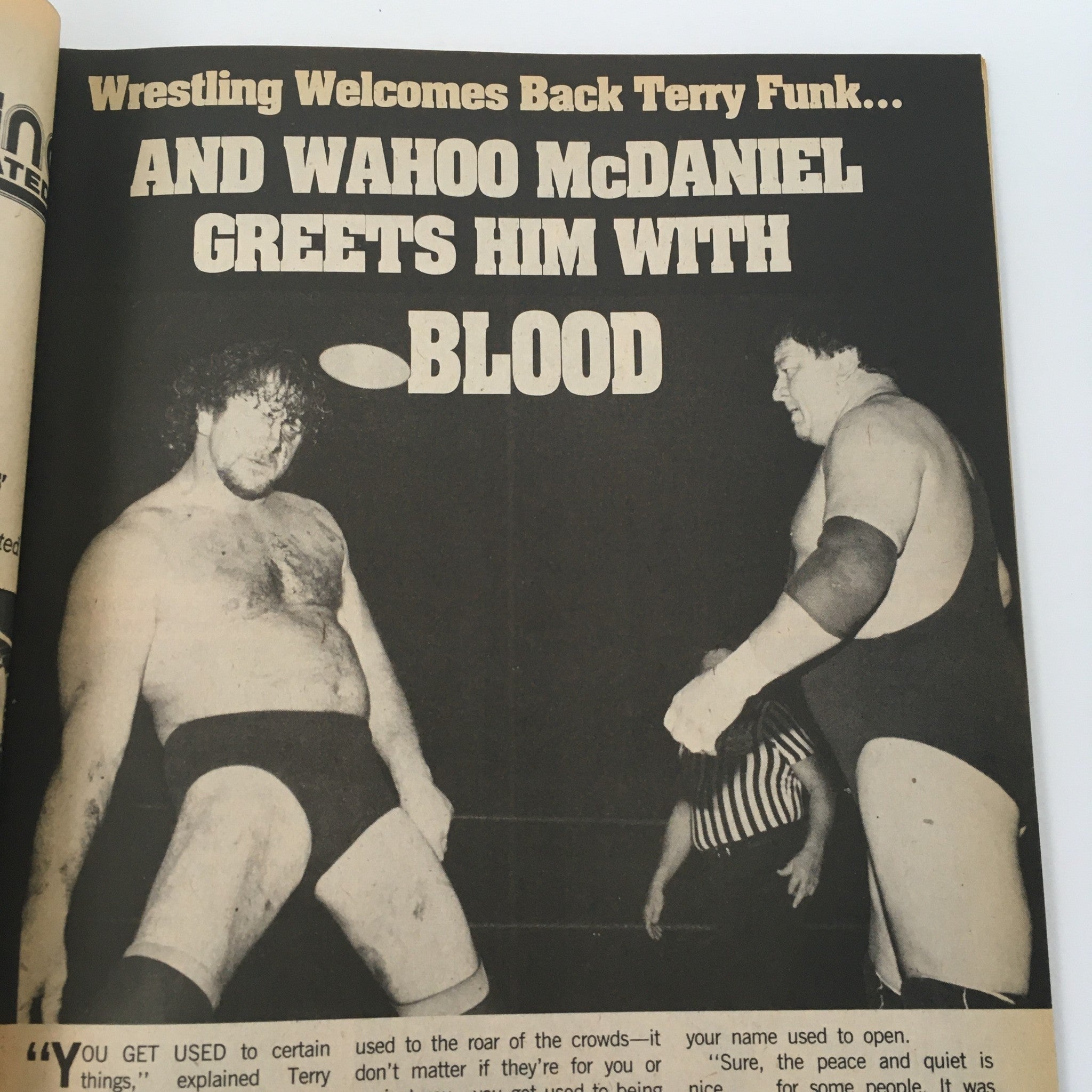 Feature page from Sports Review Wrestling Magazine May 1985 titled 'Wrestling Welcomes Back Terry Funk... AND WAHOO McDANIEL GREETS HIM WITH BLOOD,' showcasing iconic wrestling narratives and moments.