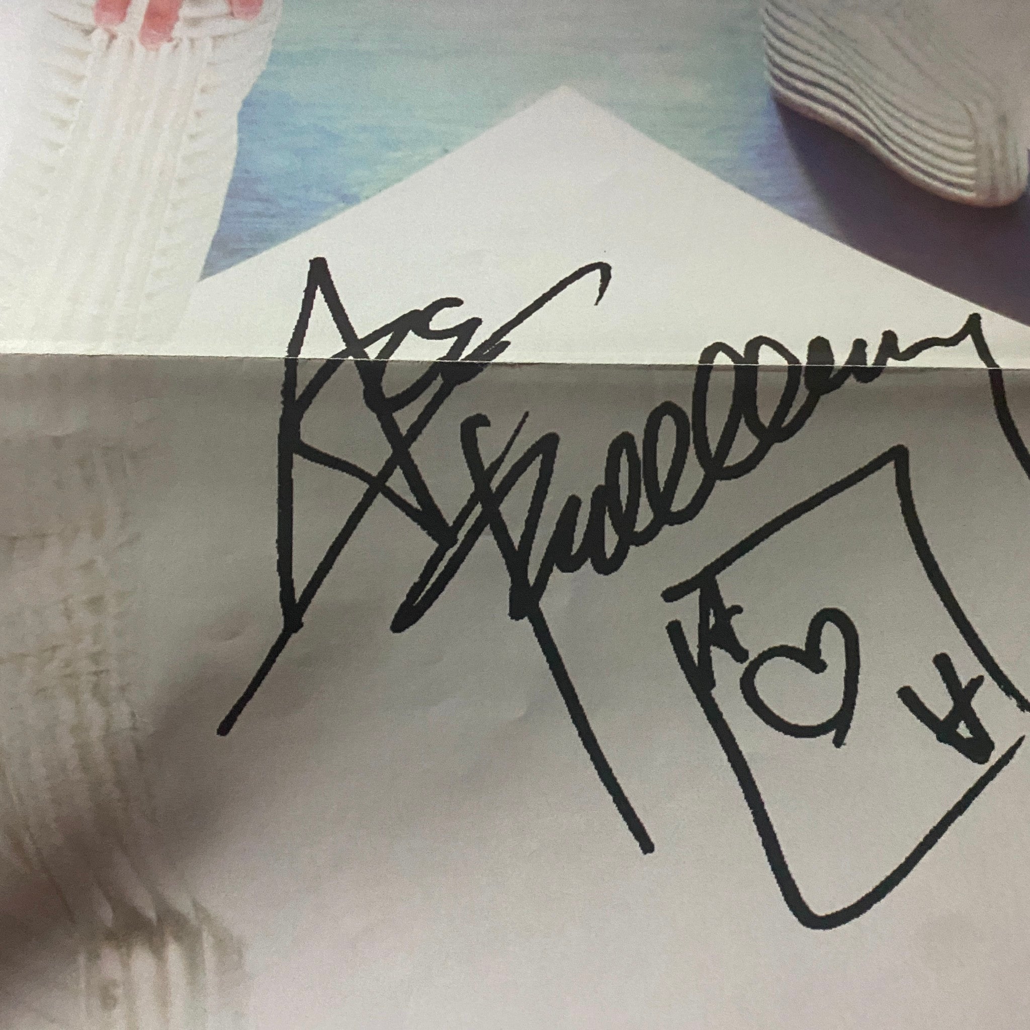 Autographed page from the Official KISS Magazine 1999 Issue #2 featuring the signature of Ace Frehley, adding to the magazine's collectible value.