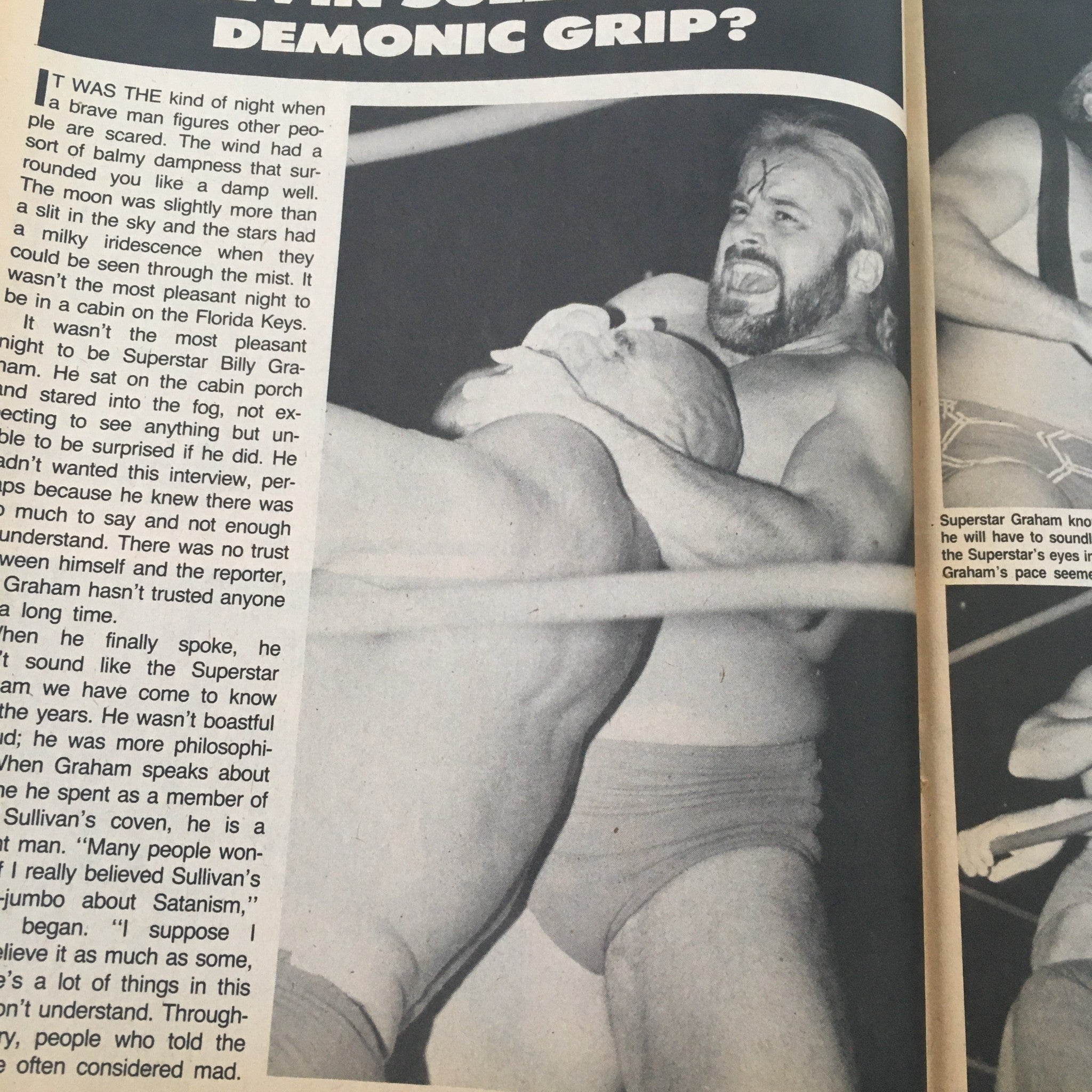 Image of Superstar Billy Graham in a wrestling match, featured in Sports Review Wrestling Magazine February 1985, depicting the intense action between Graham and Kevin Sullivan.