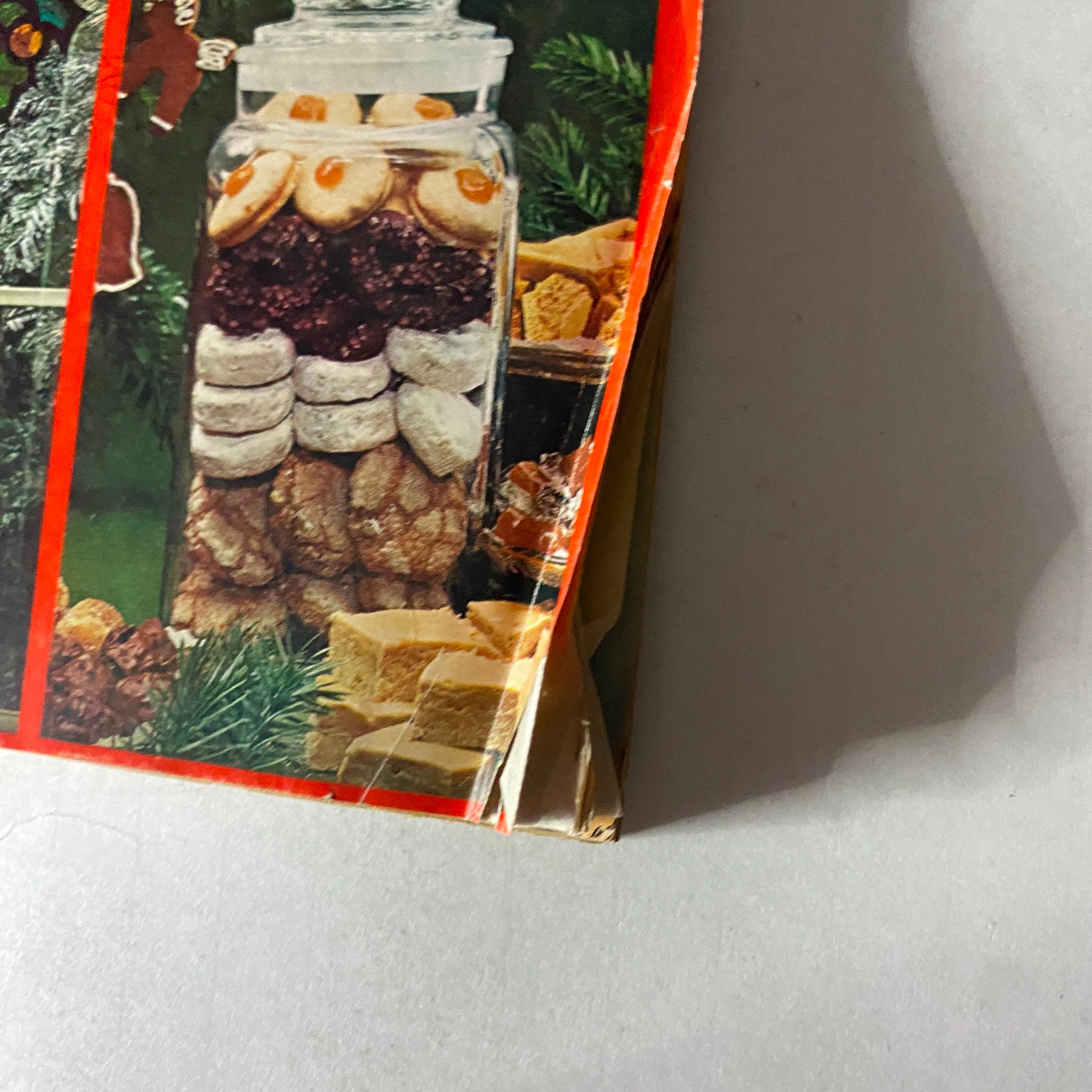 Close-up of Family Circle Magazine, December 1976 edition highlighting holiday cookies in a glass jar, emphasizing festive treats and decoration ideas.