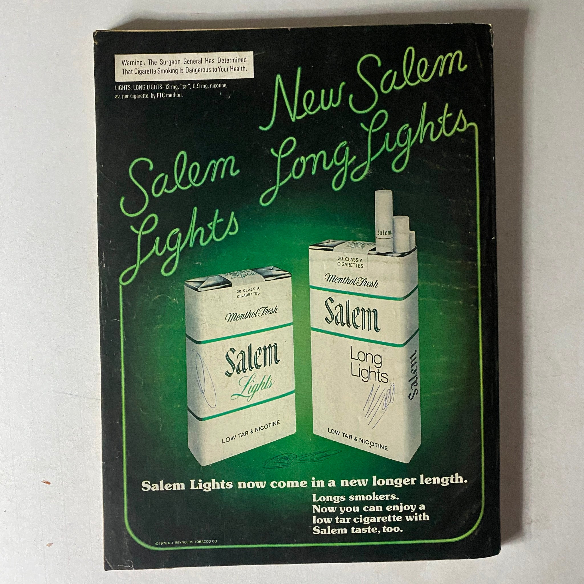 Advertisement for Salem Lights cigarettes, illustrating cigarette packaging design, from the Family Circle Magazine December 1976 edition.
