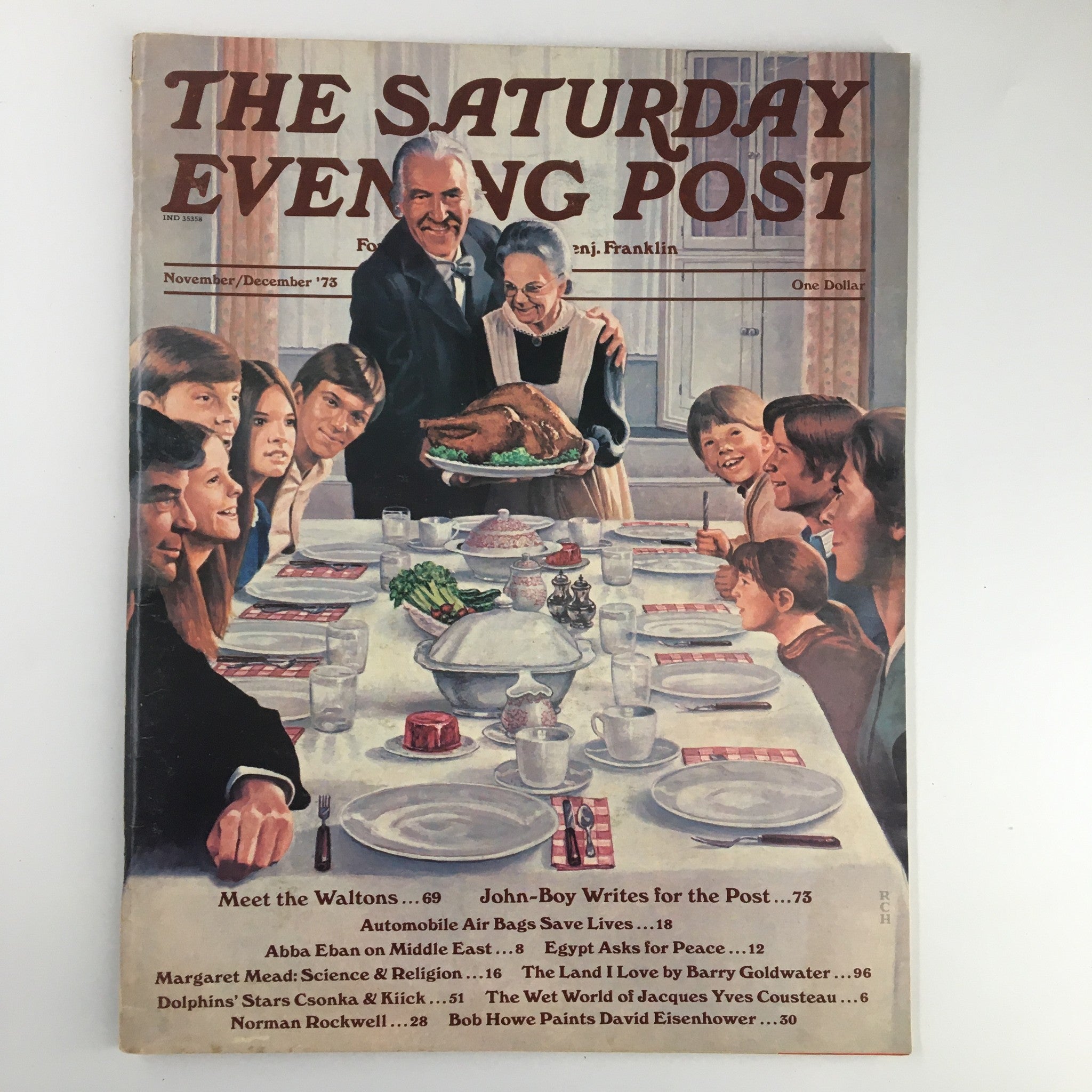 The Saturday Evening Post November 1973 cover featuring a warm Thanksgiving scene with a family gathered around the dinner table, showcasing a roasted turkey and joyful expressions, encapsulating nostalgia and celebration.